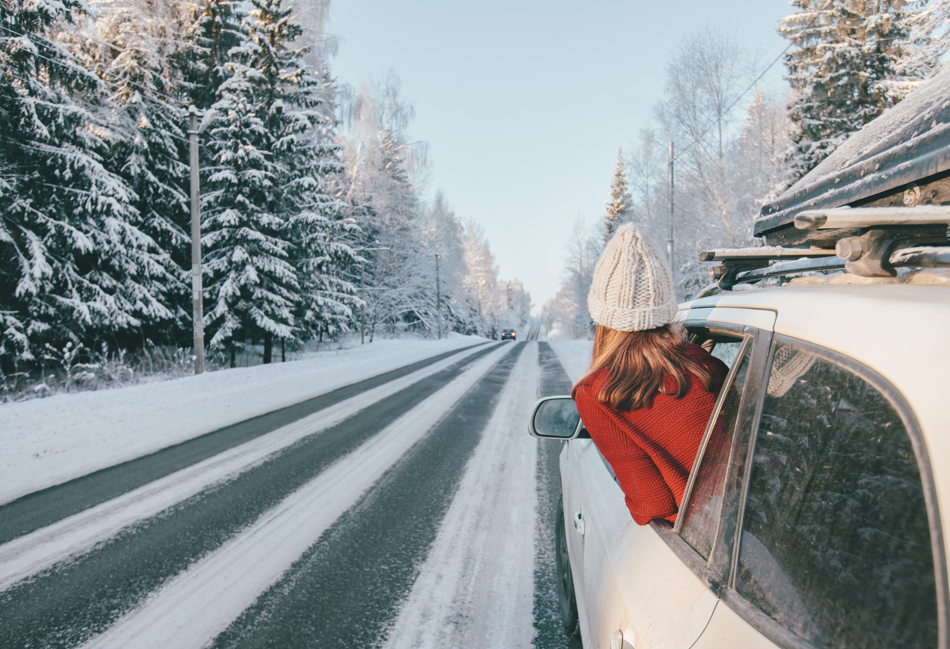 Rear view of teen girl in car over snowy forest on winter roadtrip to the nordic way; Shutterstock ID 1521178619