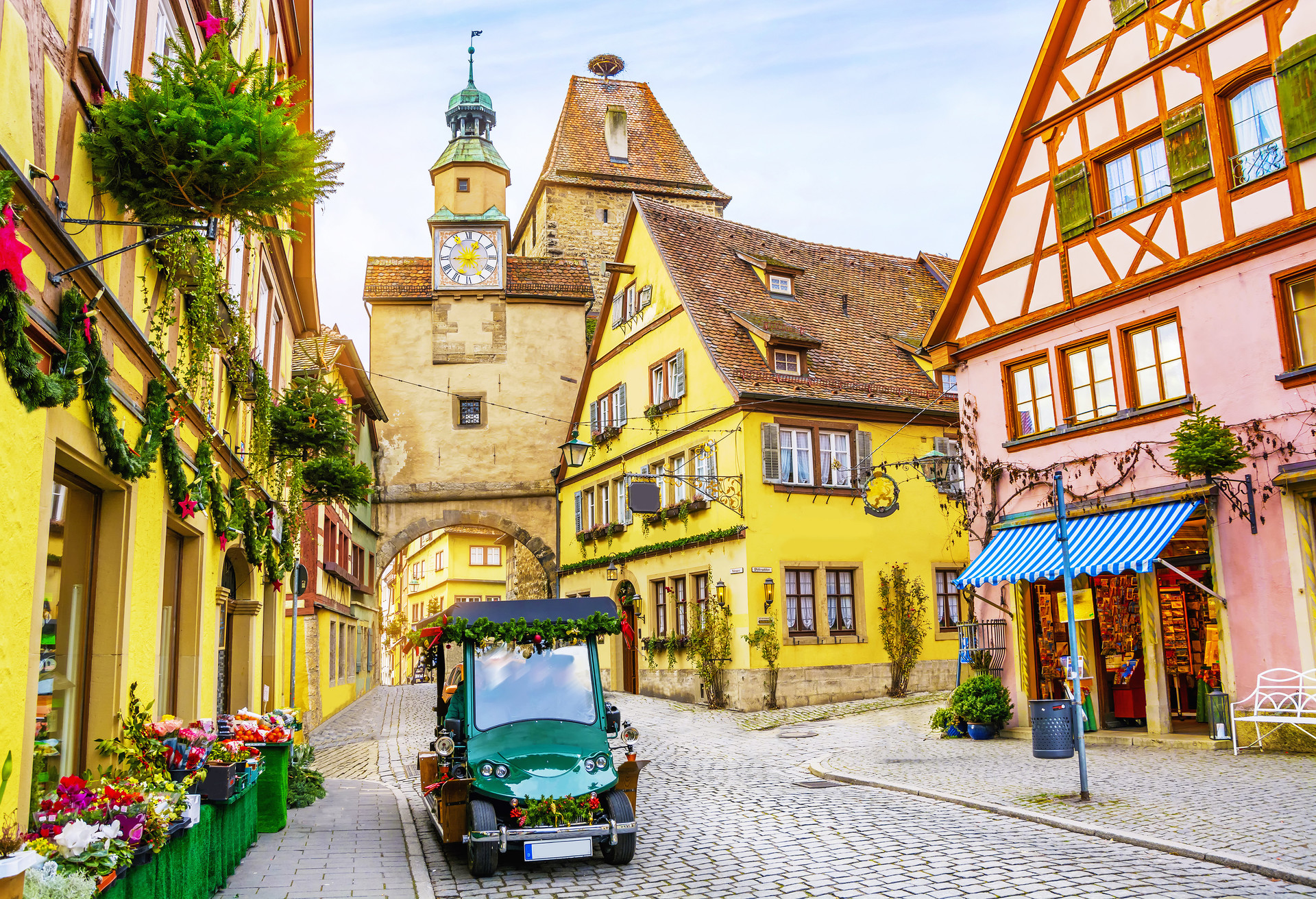 Touristic retro car on picturesque street, decorated for Christmas holiday in Rothenburg ob der Tauber, picturesque medieval historic town in Bavaria, Germany; Shutterstock ID 709473610; Purpose: ; Brand (KAYAK, Momondo, Any):