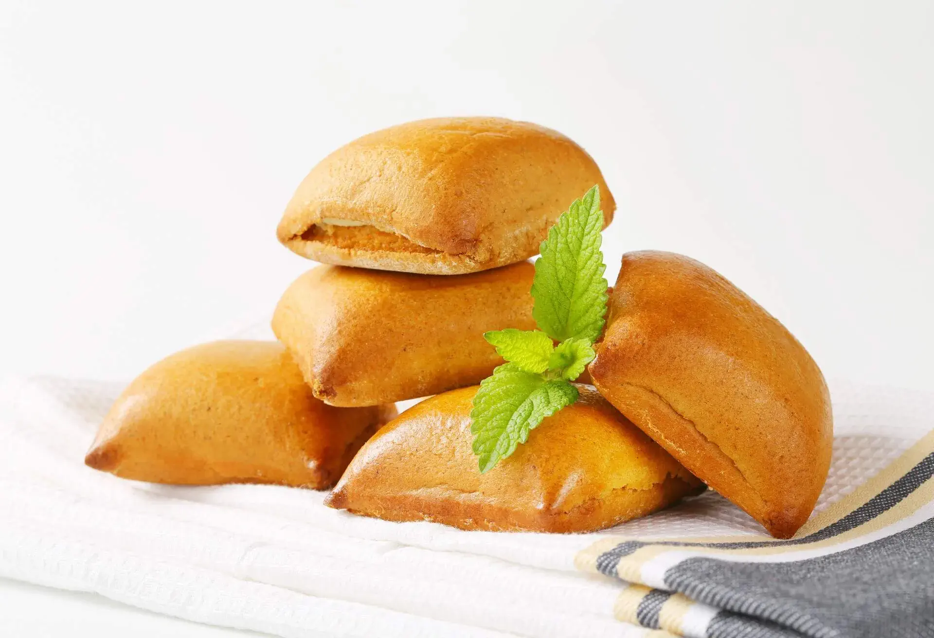 heap of biberli, swiss traditional gingerbreads with almond filling on folded dishtowel 