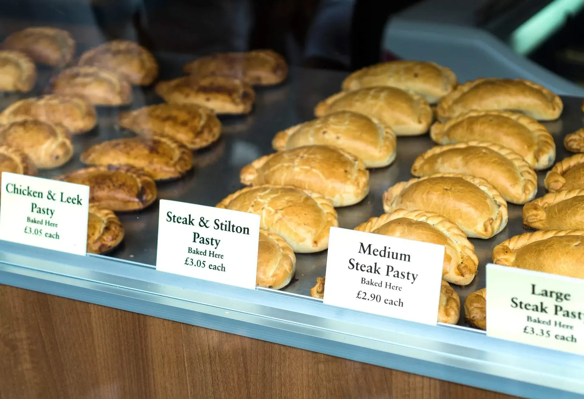 Different pasties being displayed in a windows shop in Cornwall. 