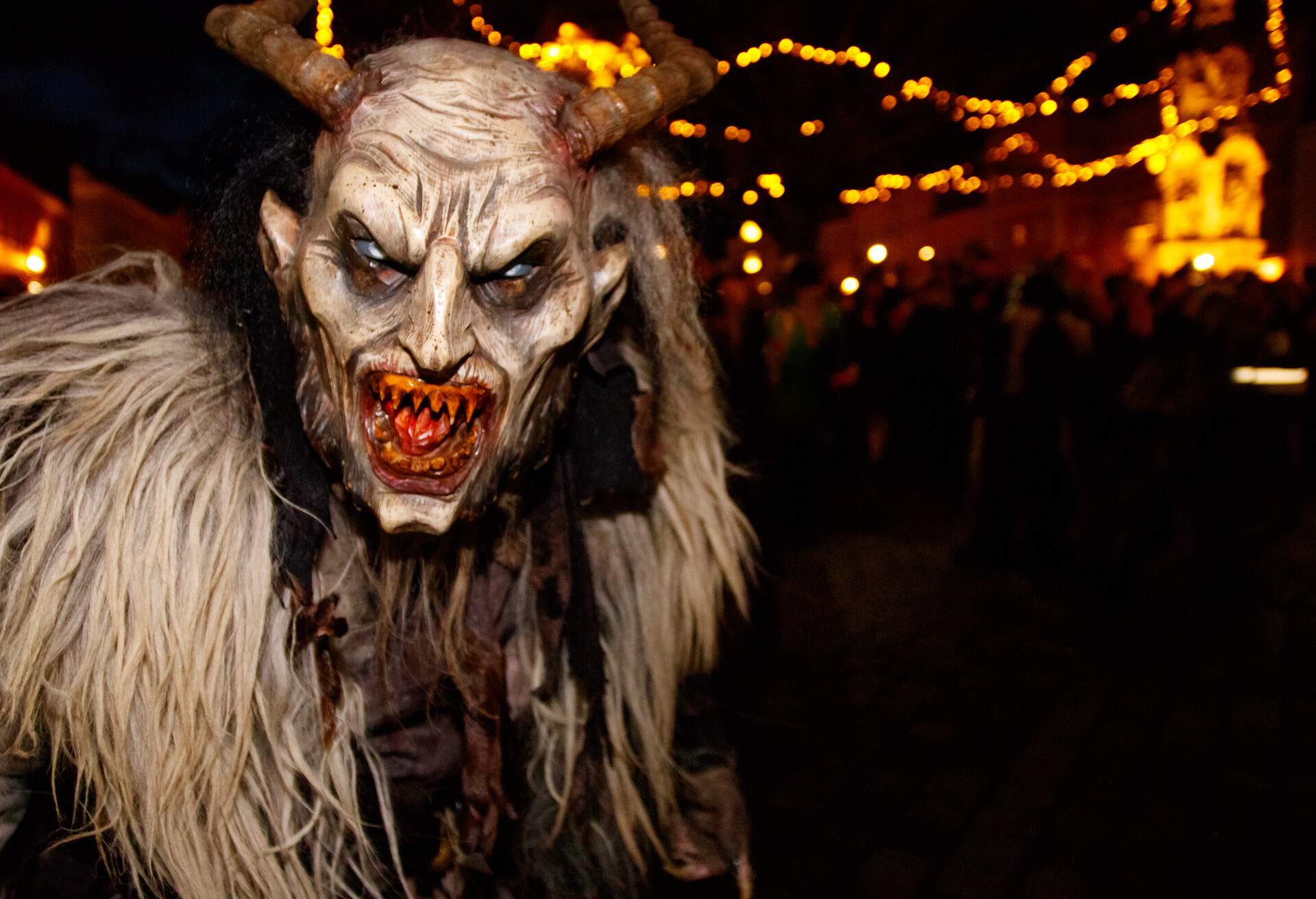 Horned devil in traditional krampuslauf with wooden masks in Retz, Austria. The Krampus is in the tradition of a fright figure in the company of St. Nicholas; Shutterstock ID 1294383694