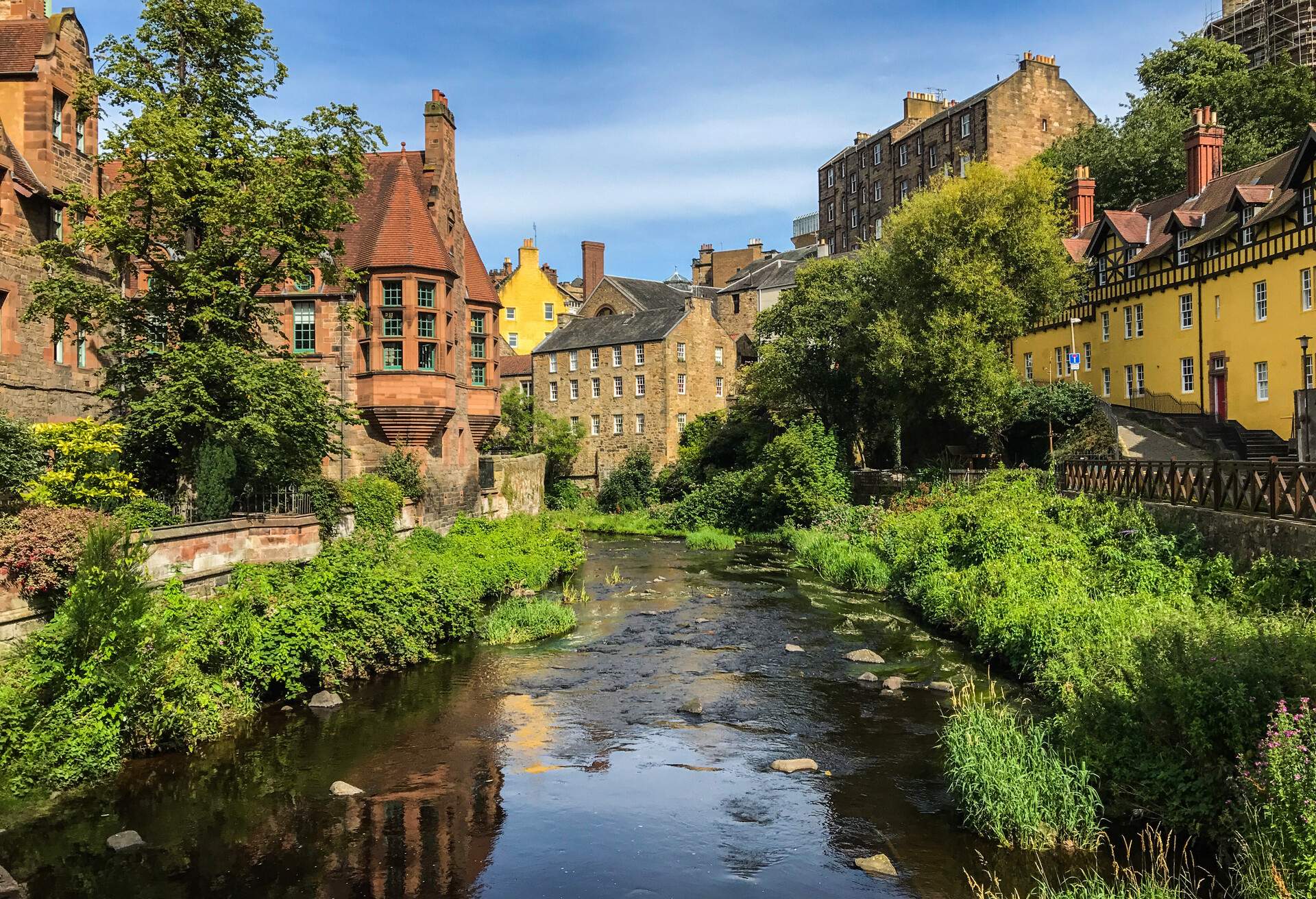 Tranquil Edinburgh summer scene of Water of Leith flowing through picturesque and historic Dean Village