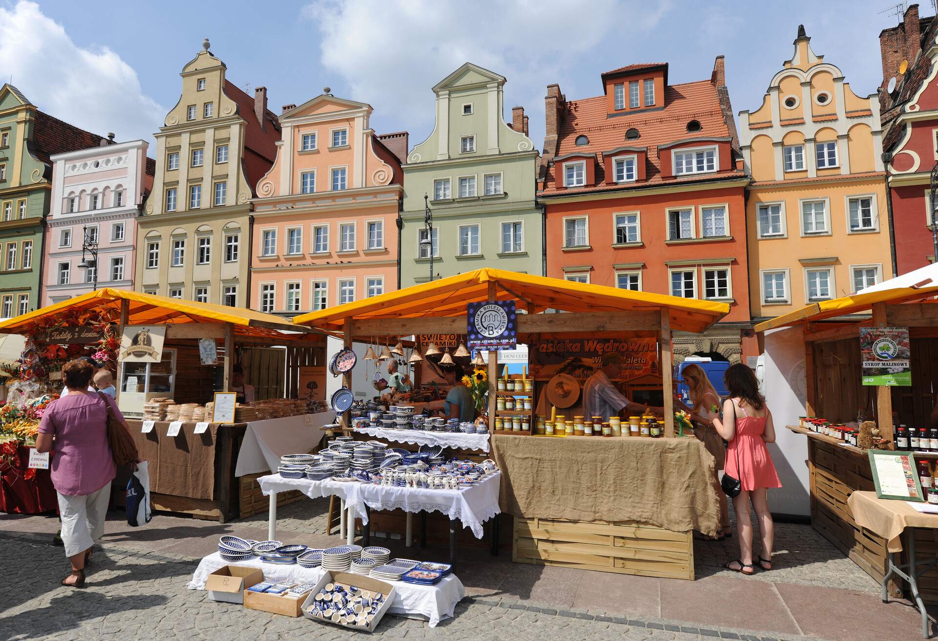 Market stalls in Salt Square, Plac Solny, including traditional pottery, honey and flowers. 