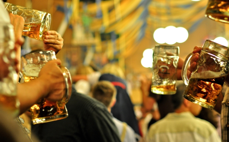 octoberfest men are drinking the beer