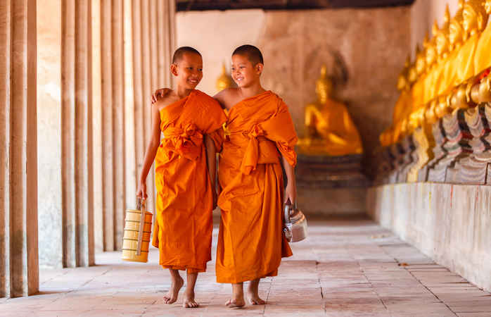 Two novices walking and talking in old temple at Ayutthaya Province, Thailand