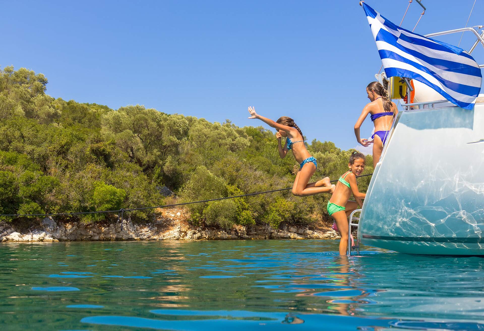 Children jumping from the sailboat