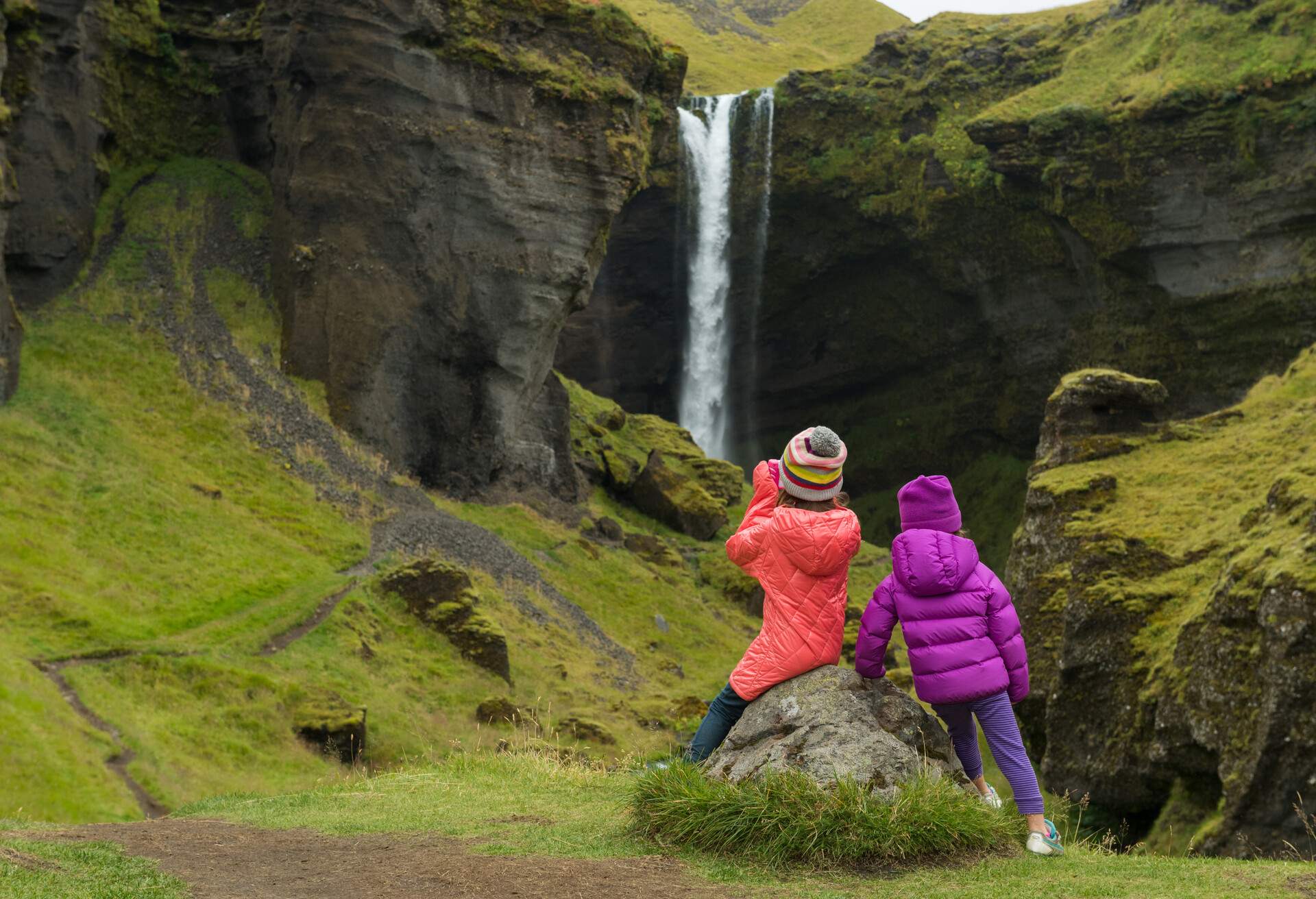 Sisters hiking to an incredible waterfall in Iceland