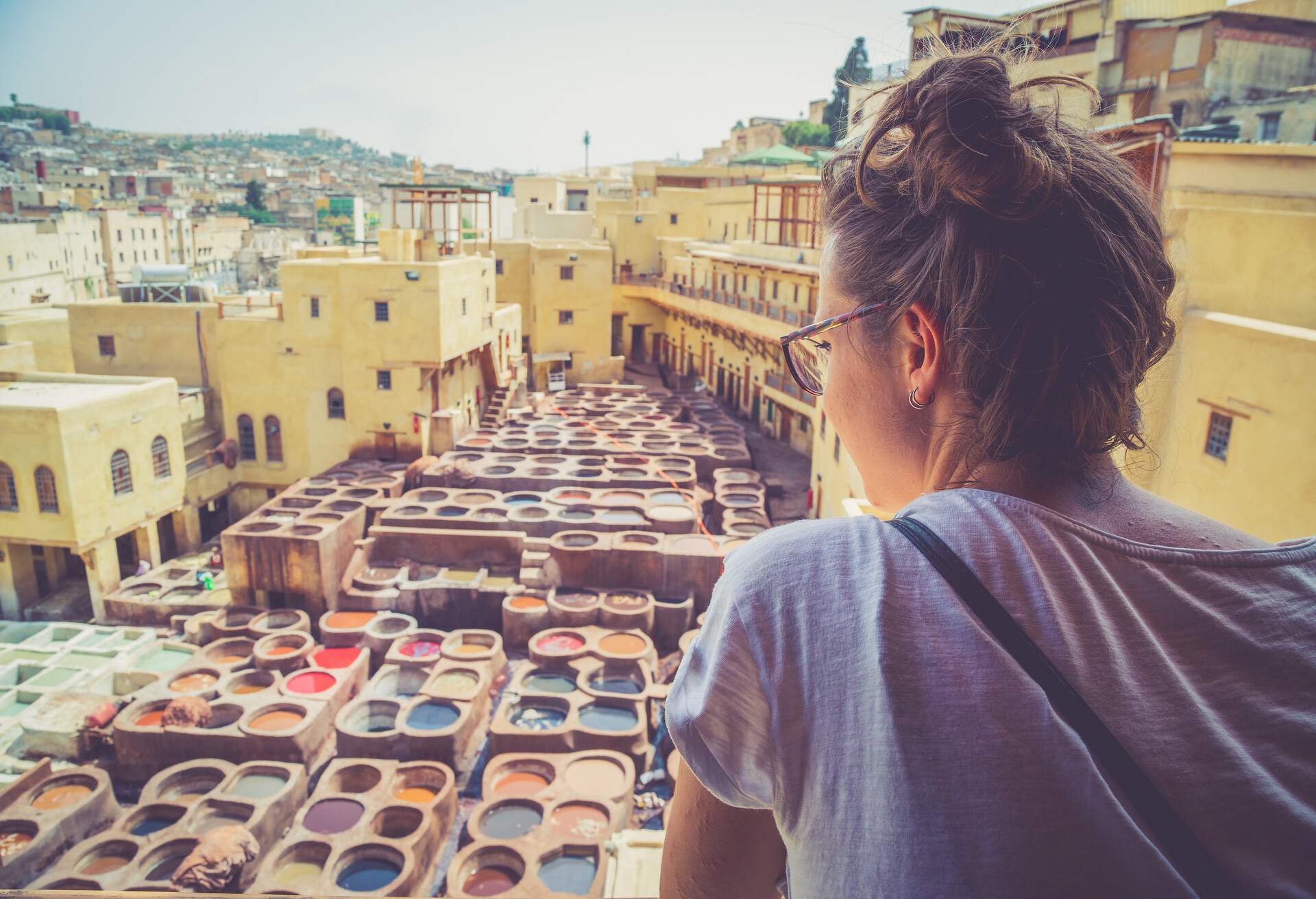 happy tourist girl watching the typical tannery in the middle of souk of Fez; Shutterstock ID 736166941