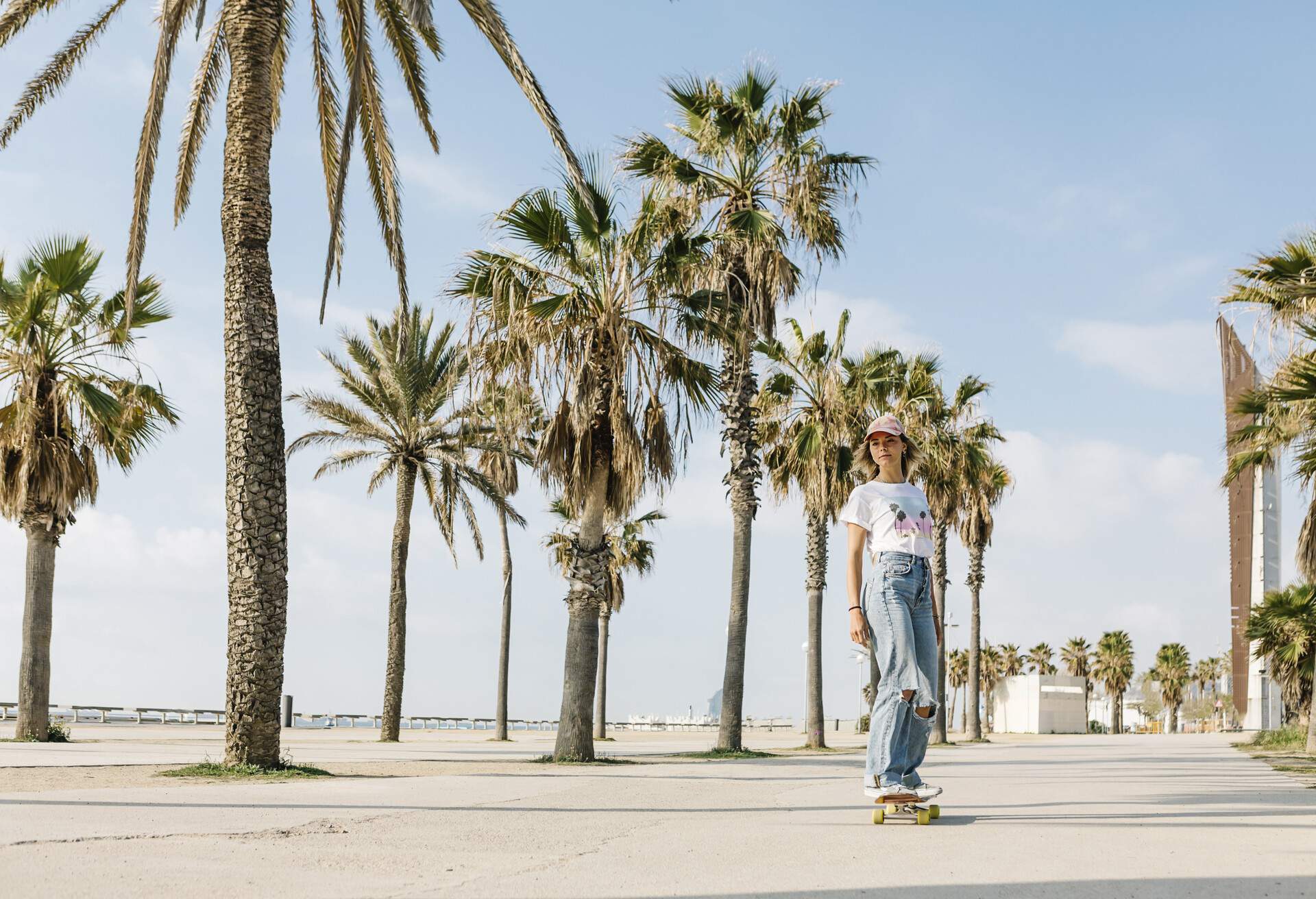 dest_spain_barcelona_theme_beach_skate_palm_trees_gettyimages-1319659624_universal_within-usage-period_83582