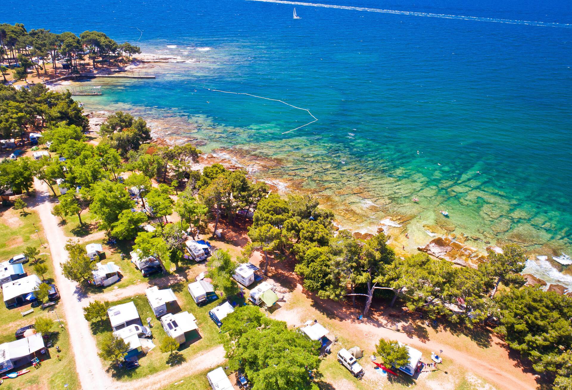 Camping by the sea and crystal clear stone beach aerial view in Savudrija, Istria region of Croatia