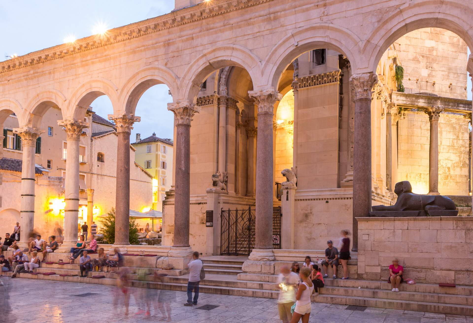 Split, Croatia - September 5, 2015: Tourists at the Diocletian's Palace's lit peristyle in Split, Croatia, at dusk.