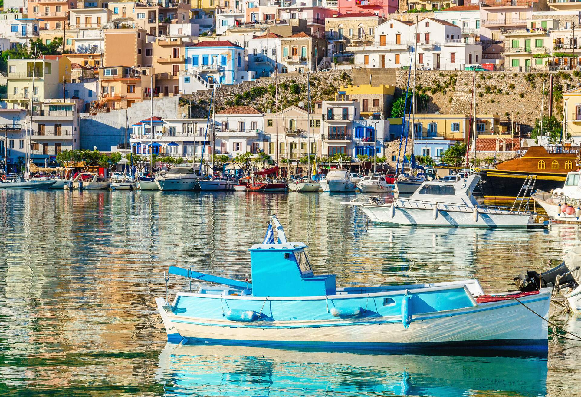 Small wooden colorful fishermen's boat in cosy Greek Port, Greece