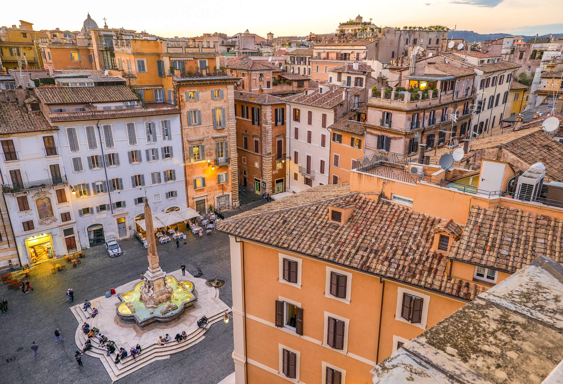 A breathtaking view of the roofs and terraces of Rome from the top of the Pantheon district, in the Rione Pigna (Pigna Village), in the historic heart of the Eternal City. Below the Baroque fountain designed in 1575 by Giacomo della Porta and the Egyptian obelisk in Piazza della Rotonda (Piazza del Pantheon). In 1980 the historic center of Rome was declared a World Heritage Site by Unesco. Image in high definition format.