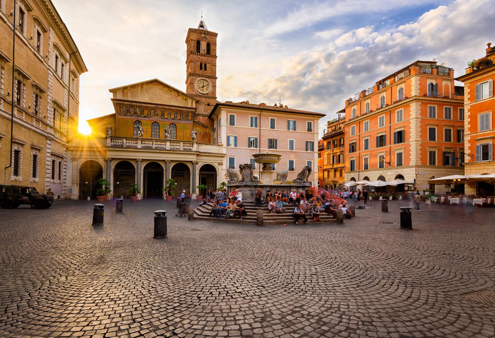 Basilica di Santa Maria in Trastevere and Piazza di Santa Maria in Trastevere at sunset, Rome, Italy. Trastevere is rione of Rome, on west bank of Tiber in Rome. Architecture and landmark of Rome.; Shutterstock ID 676279045; Purpose: Content; Brand (KAYAK, Momondo, Any): Momondo