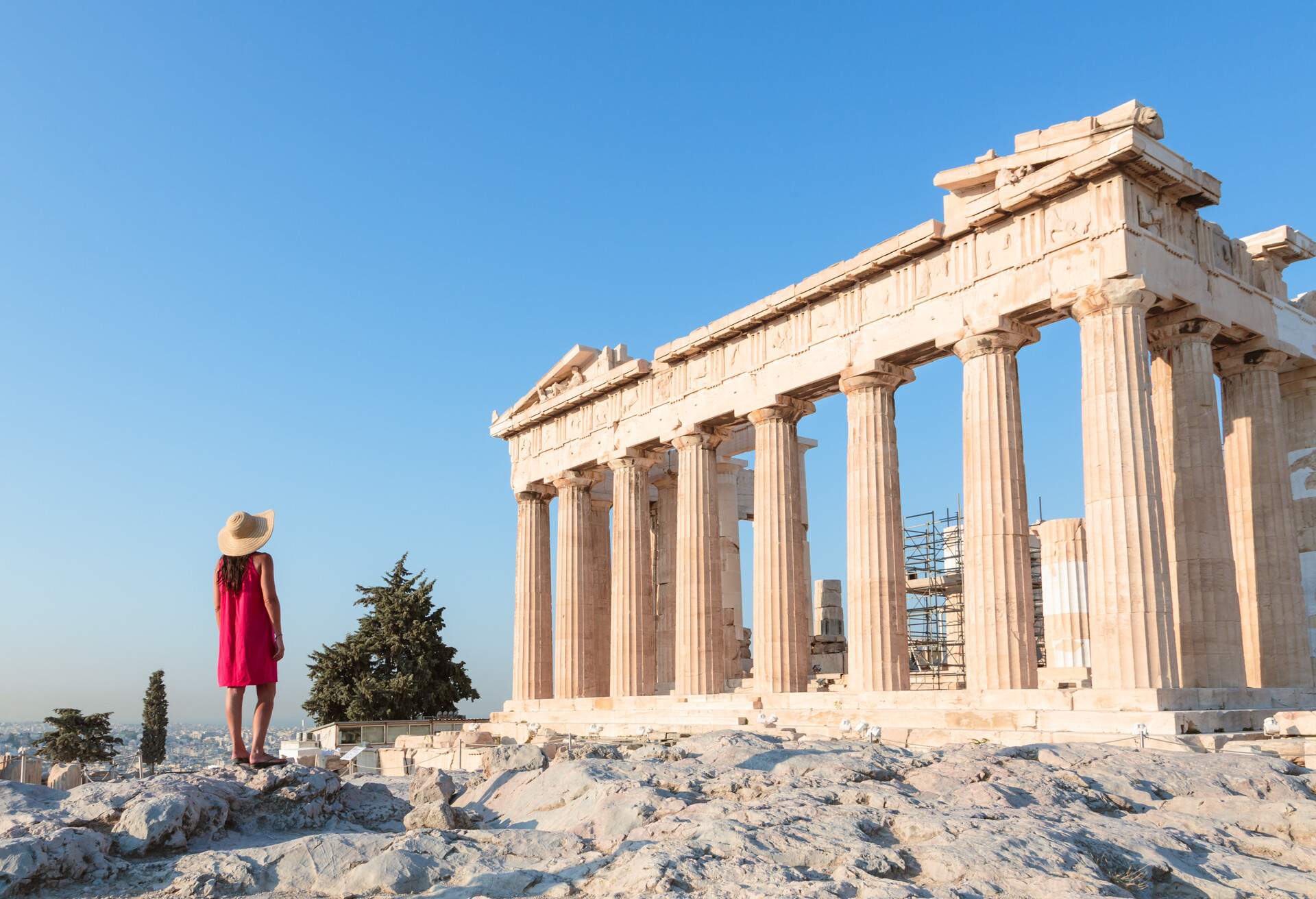 Woman looking at the famous Parthenon temple on the Acropolis, Athens, Greece