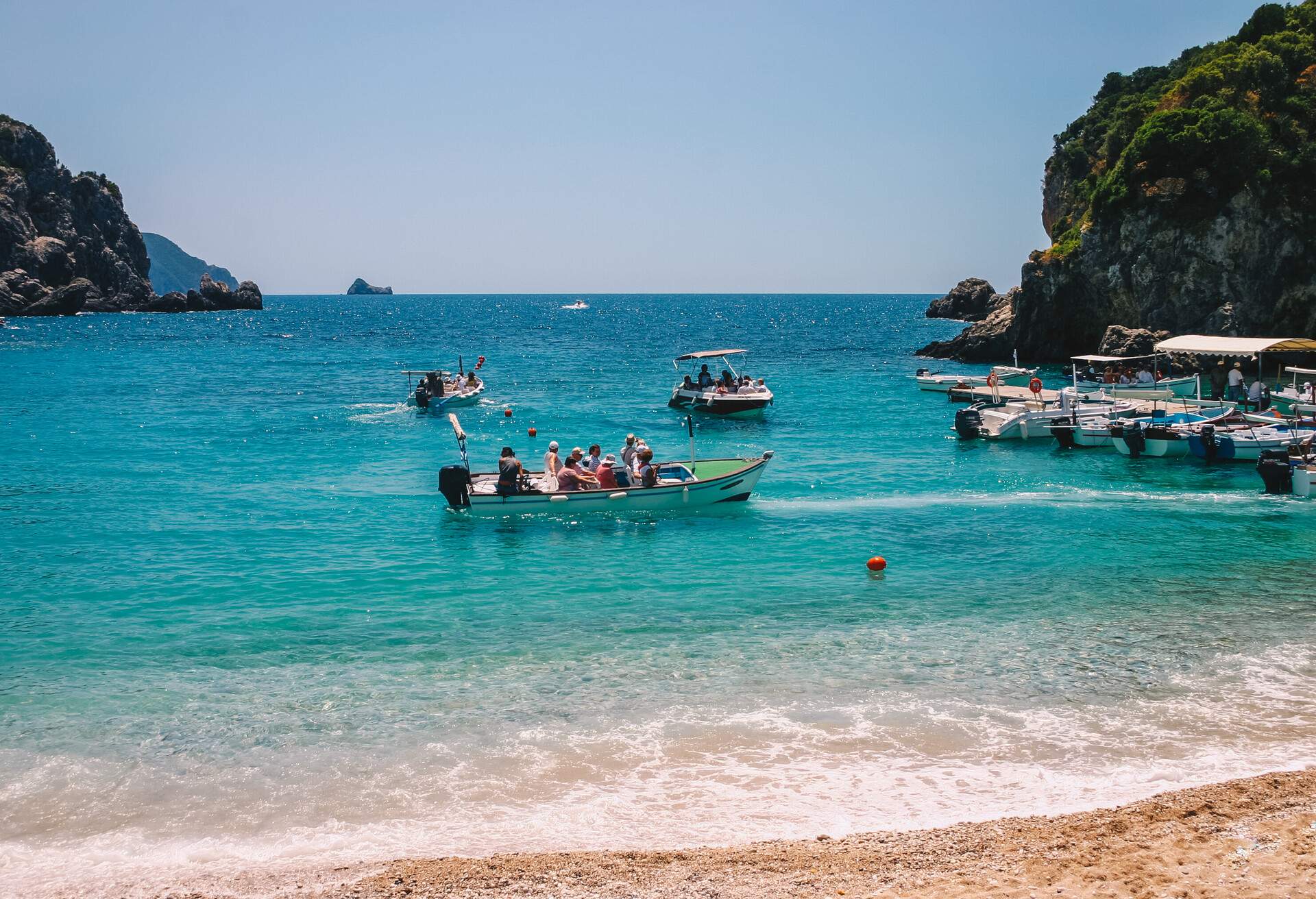 Tourist on boat going for a trip in a lagoon of Korfu Greece.; Shutterstock ID 1077305585; Purpose: Corfu; Brand (KAYAK, Momondo, Any): Any