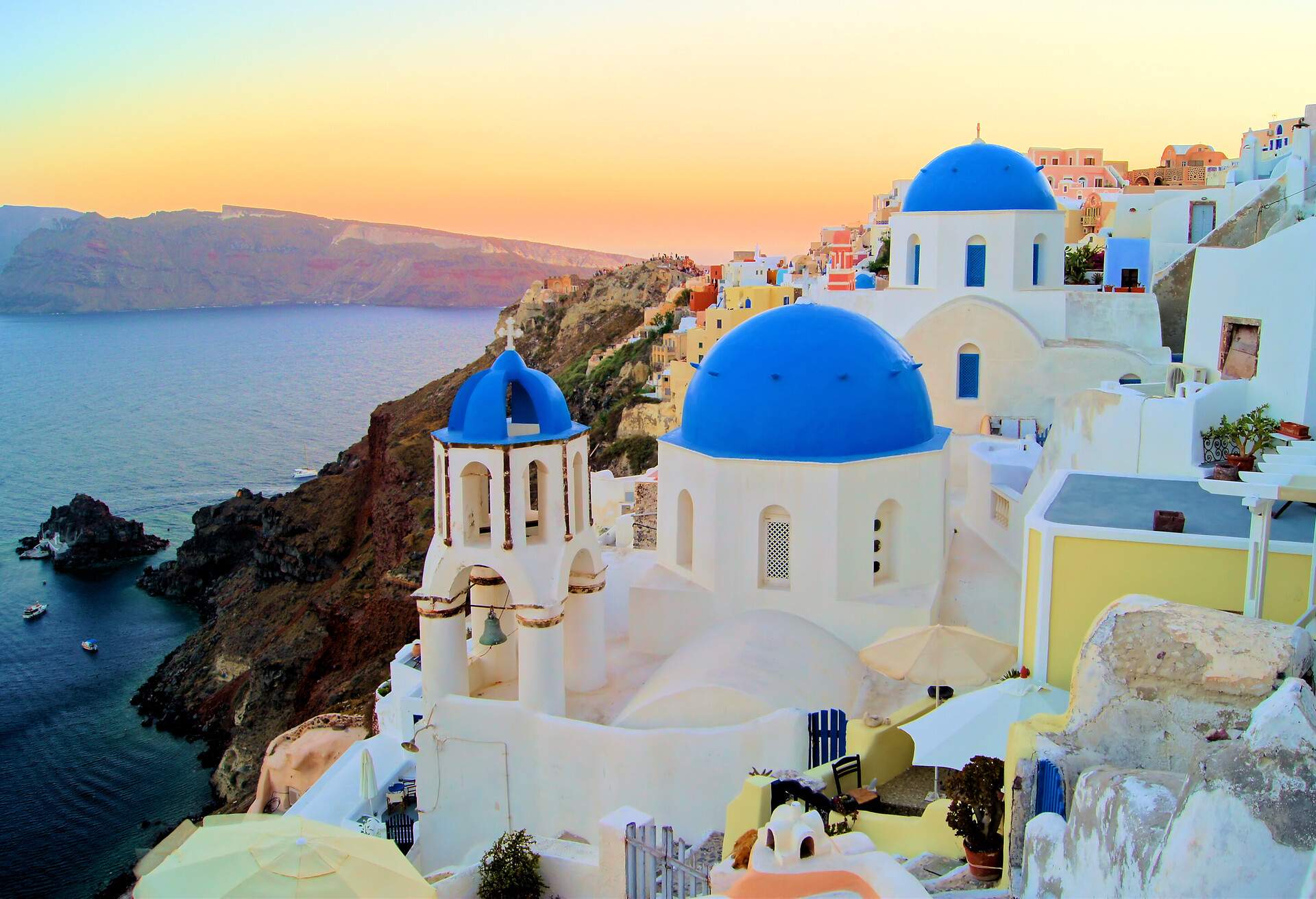 Sunset view of the blue dome churches of Santorini, Greece; Shutterstock ID 125827007; Purpose: destiny; Brand (KAYAK, Momondo, Any): any