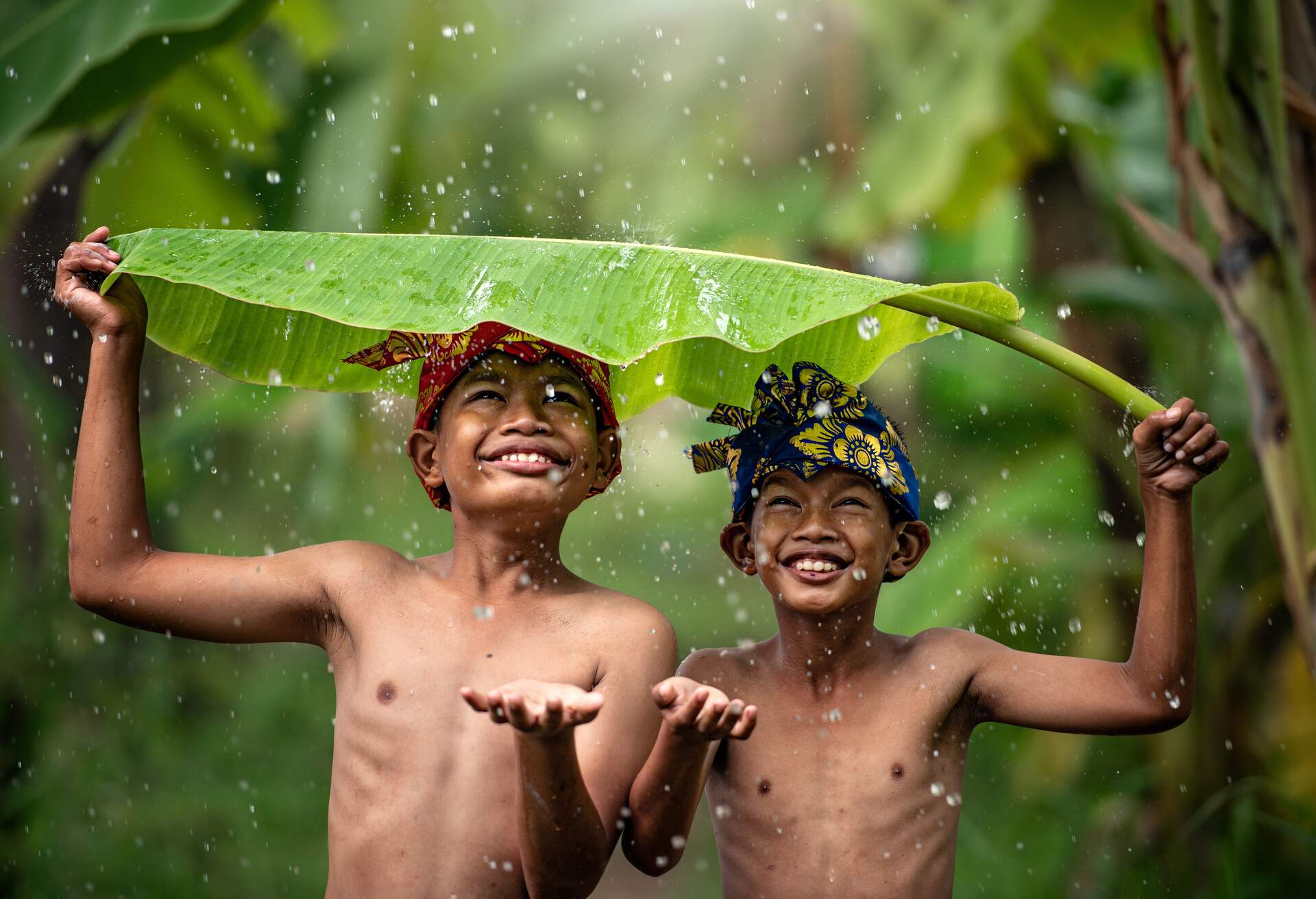 Indonesia children farmer playing rain. Asian kid smile. Indonesian concept.