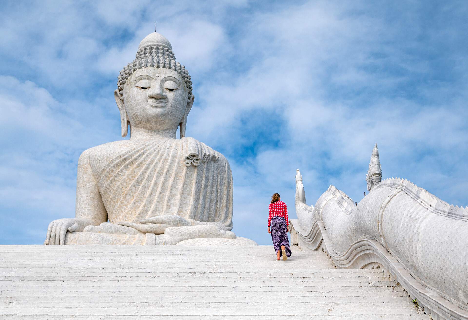 13 years old girl climbing the stairs to White marble statue of  Big Buddha in Phuket,Thailand