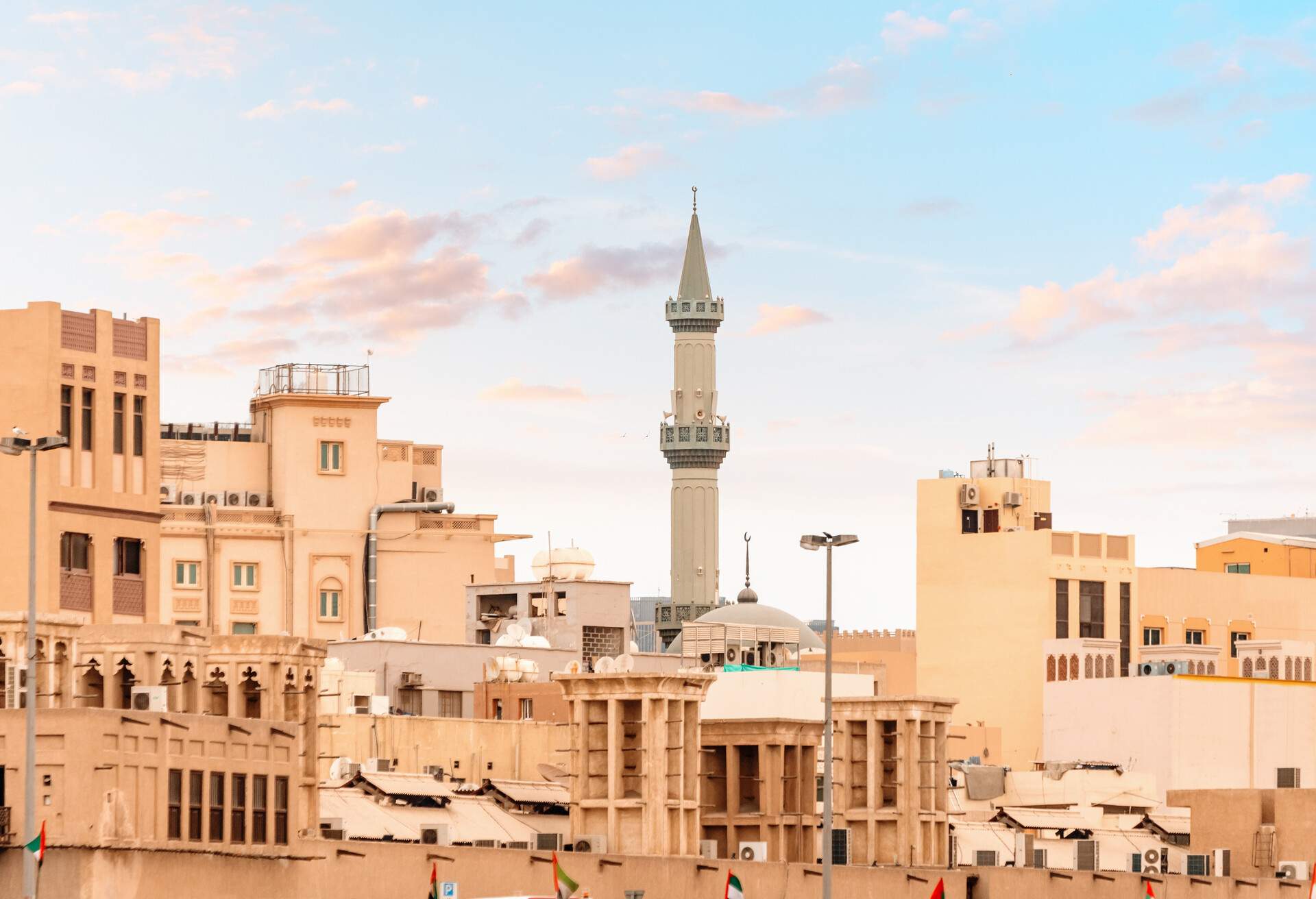 Traditional Arab houses and the towering minaret of the mosque in the neighborhood of Bur Dubai Creek and Golden Souk