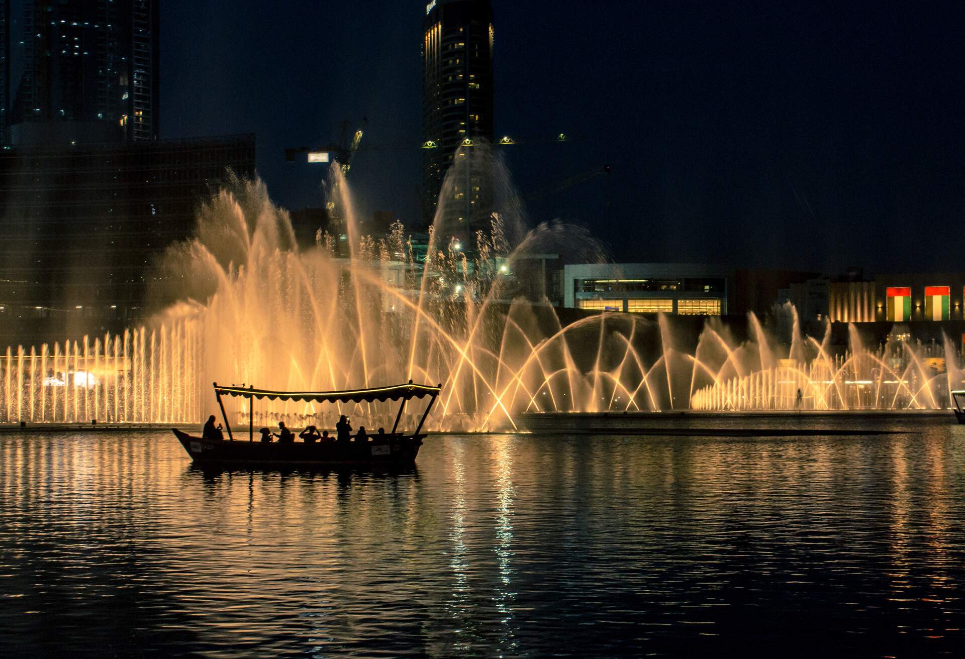 Small boats carrying tourists to watch the Dubai Fountain at the Dubai shopping mall in United Arab Emirates.