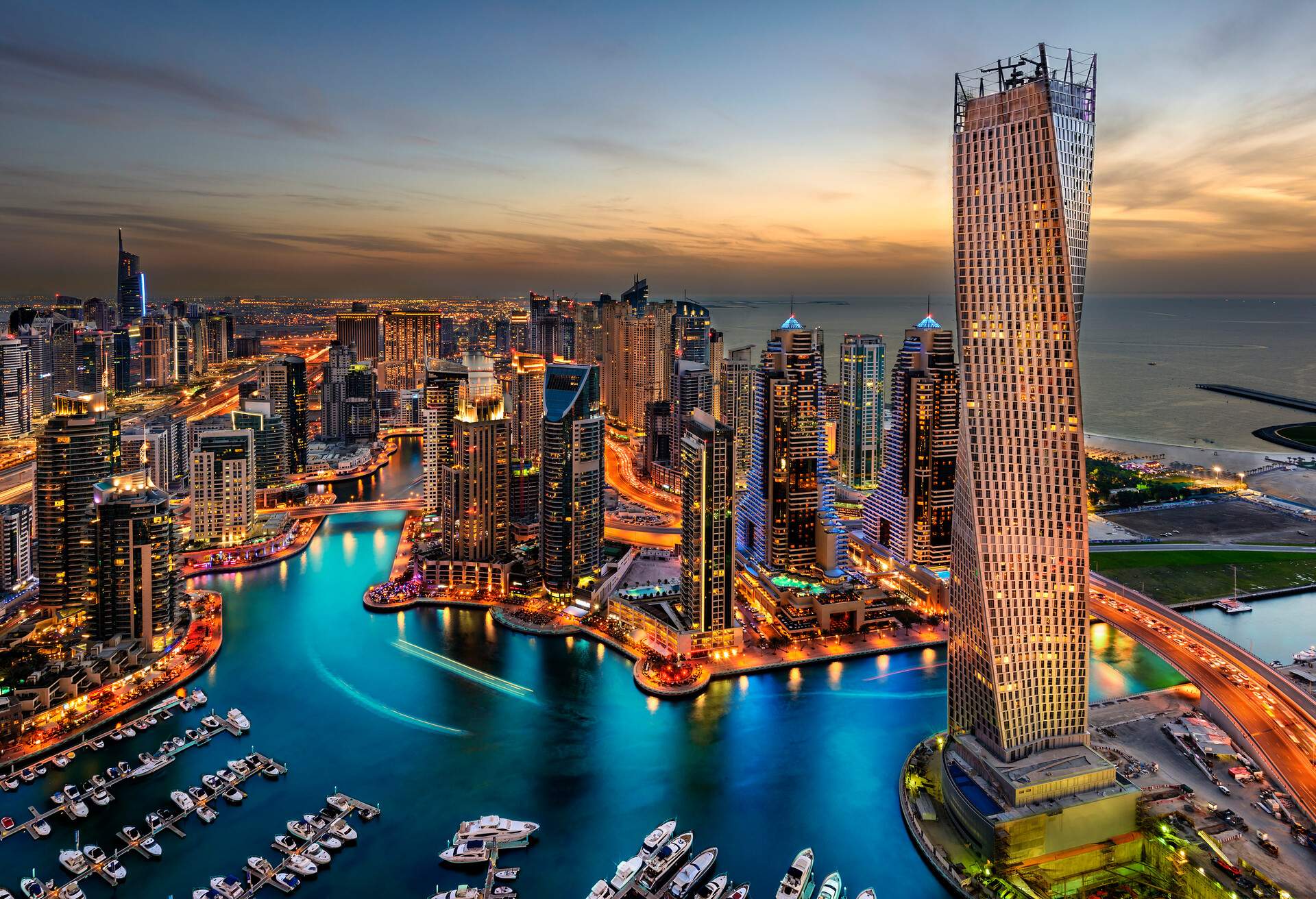 Dubai Marina from a high view showing the boats, sea, and the city scape.