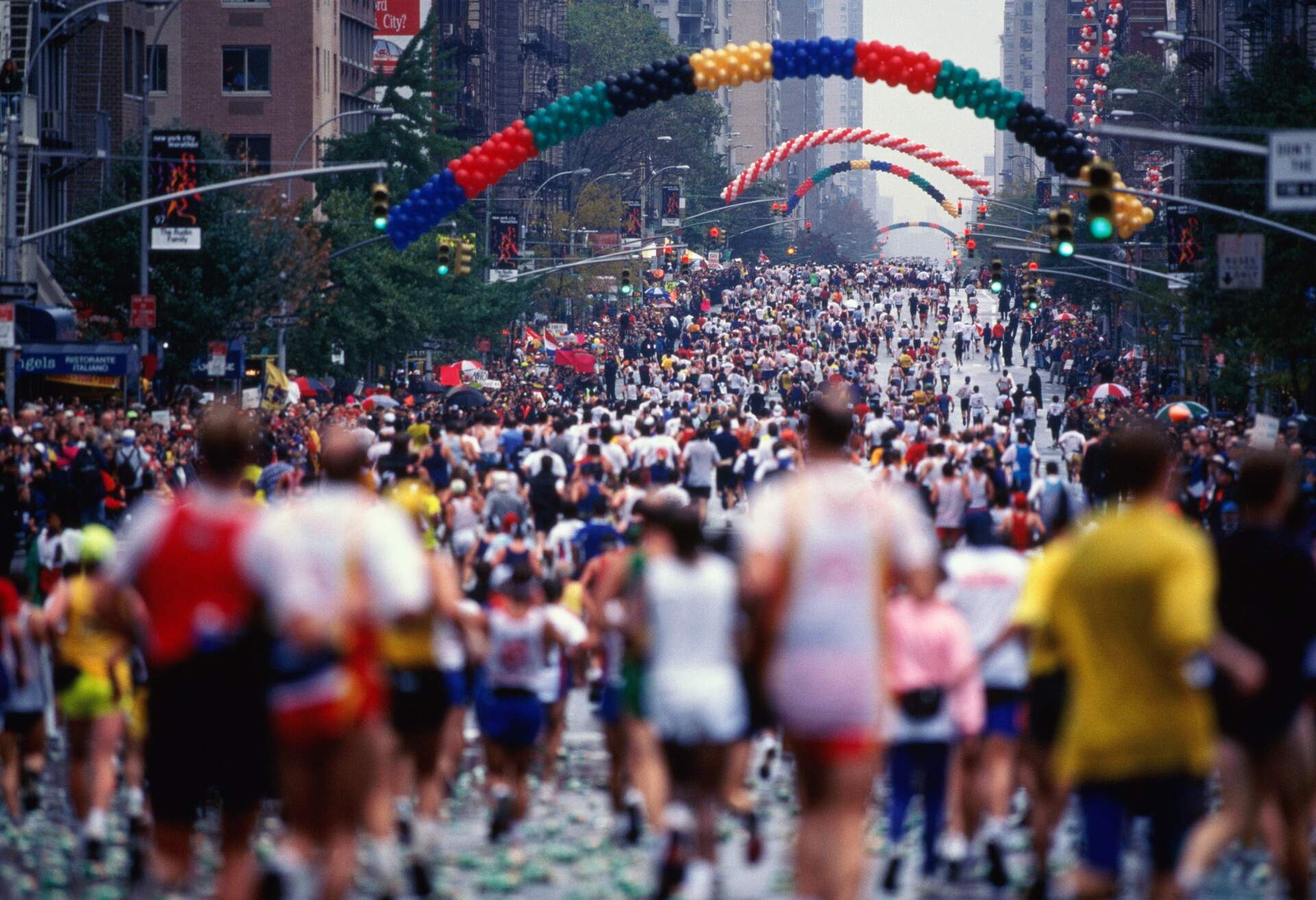 Runners on First Avenue. The New York City Marathon attracts 29,000 runners on a 26.2 mile course that begins on Staten Island at the Verrazano Narrows Toll plaza. It ends in Central Park.