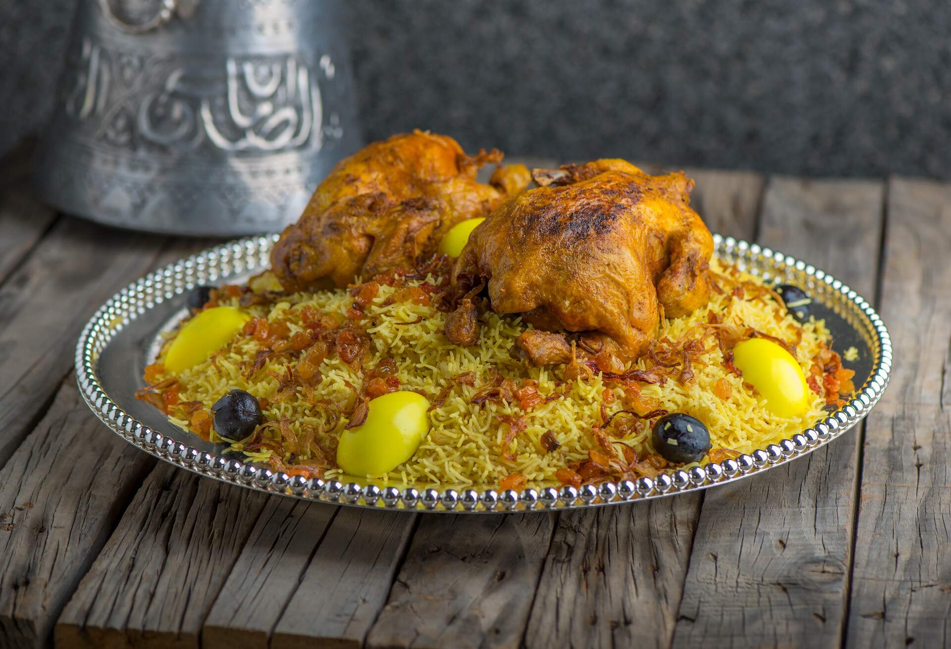 Chicken Machboos biryani served in dish side view on wooden table background