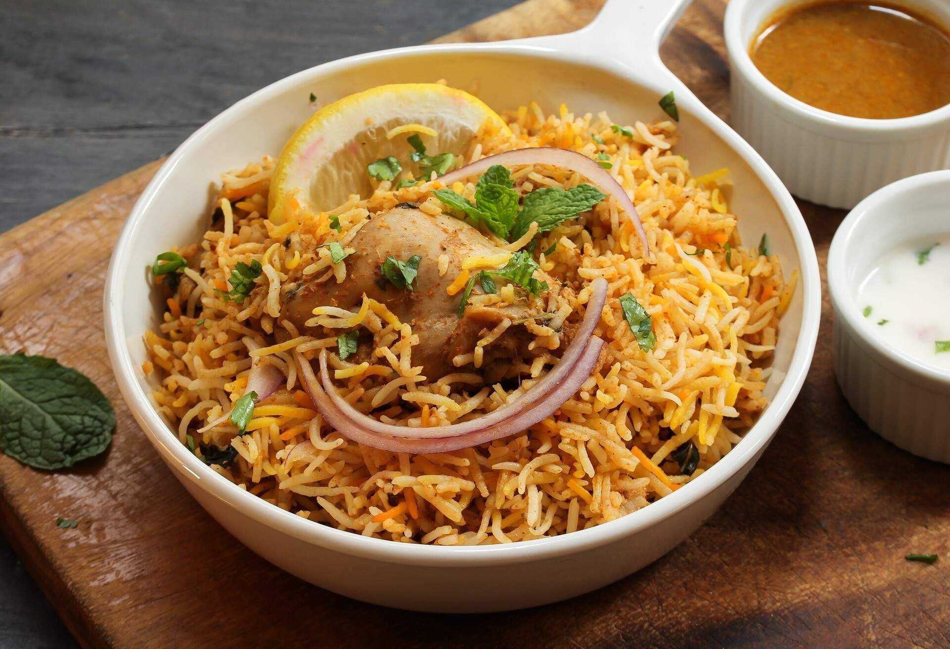 Hyderabadi Chicken Biryani served with Yogurt raita and Salan; Shutterstock ID 700079950; Purpose: ; Brand (KAYAK, Momondo, Any):