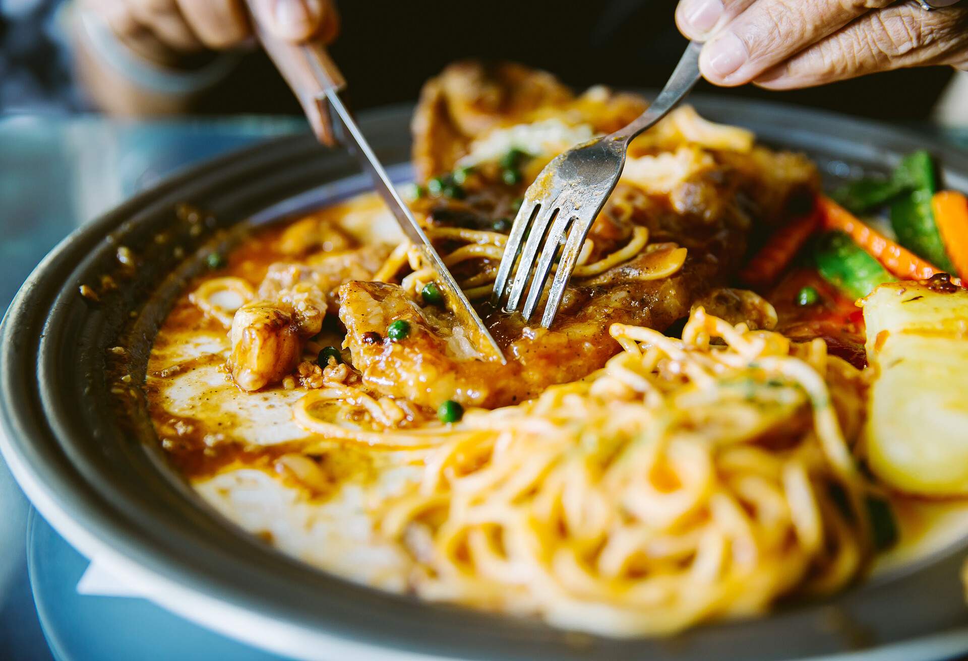 Woman eat the appetizer, hand hold Steak knife and fork.