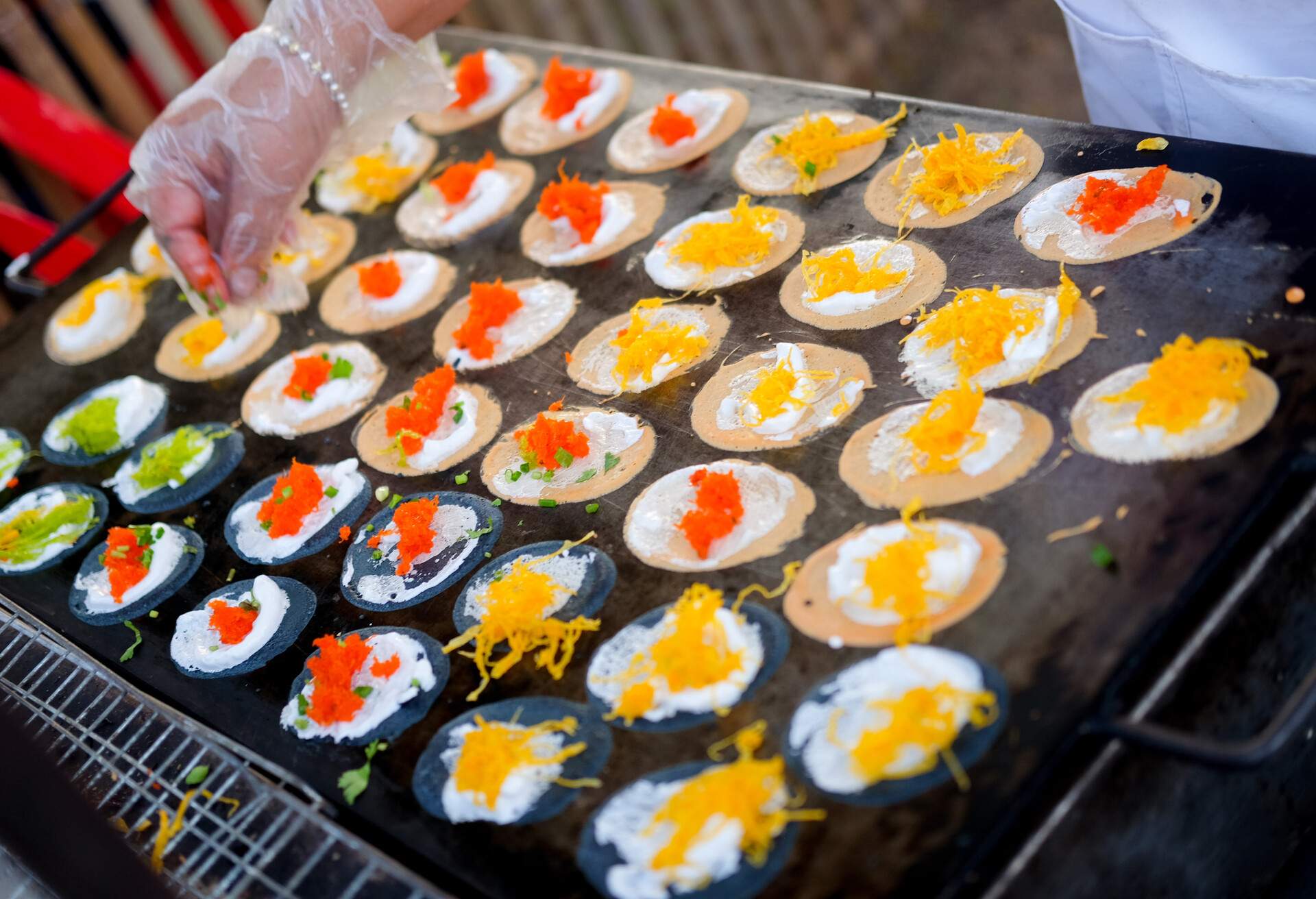 Thai people cooking ancient Indigenous called Thai sweetmeat Khanom bueang (a kind of filled pancake) at street market