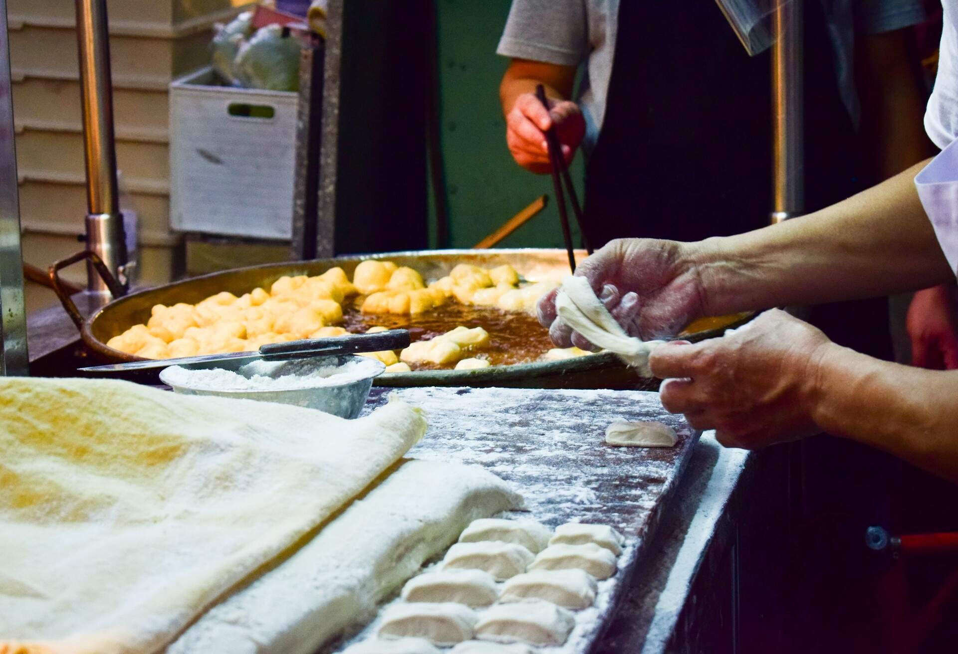 The young man was cutting the finished dough to fry the patongo flour.