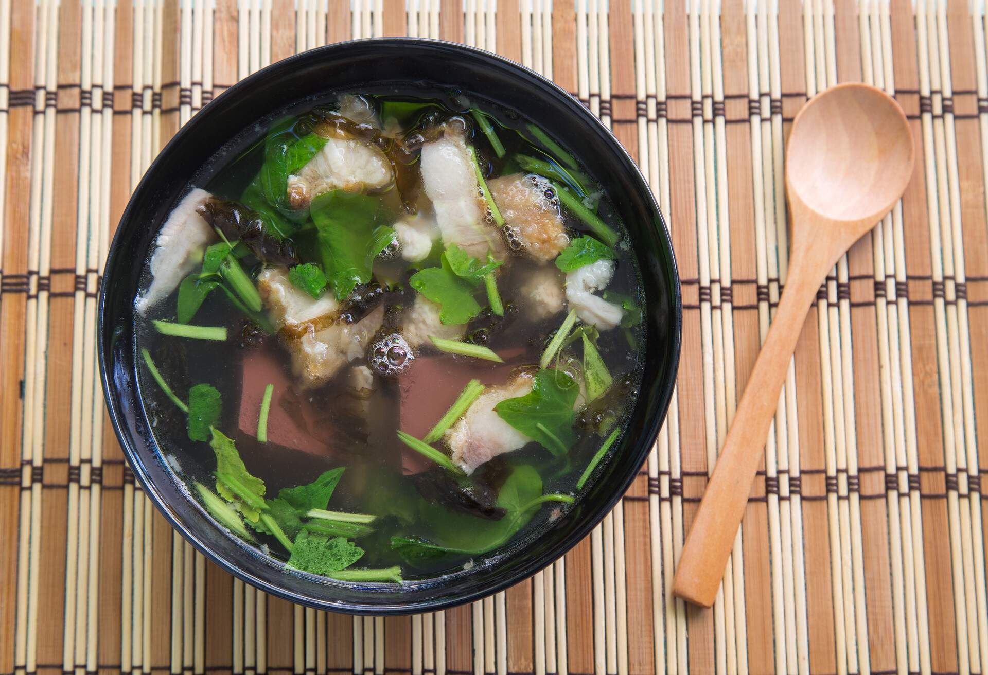 'Tom Lued Moo' Thai Style Blood Jelly with Offal Soup on wooden background.