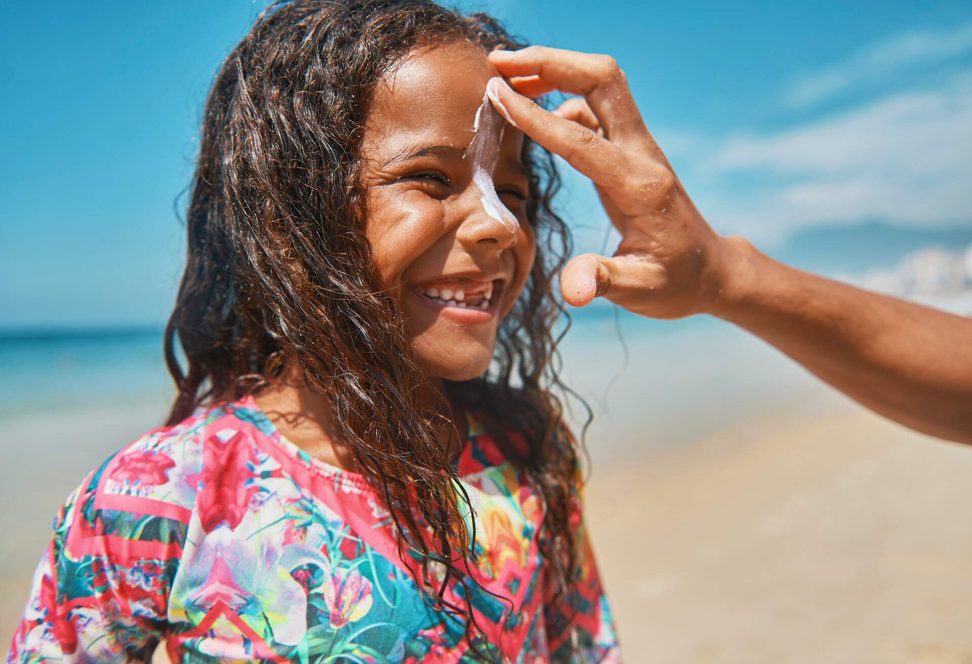 Portrait of a little girl surfer on the beach