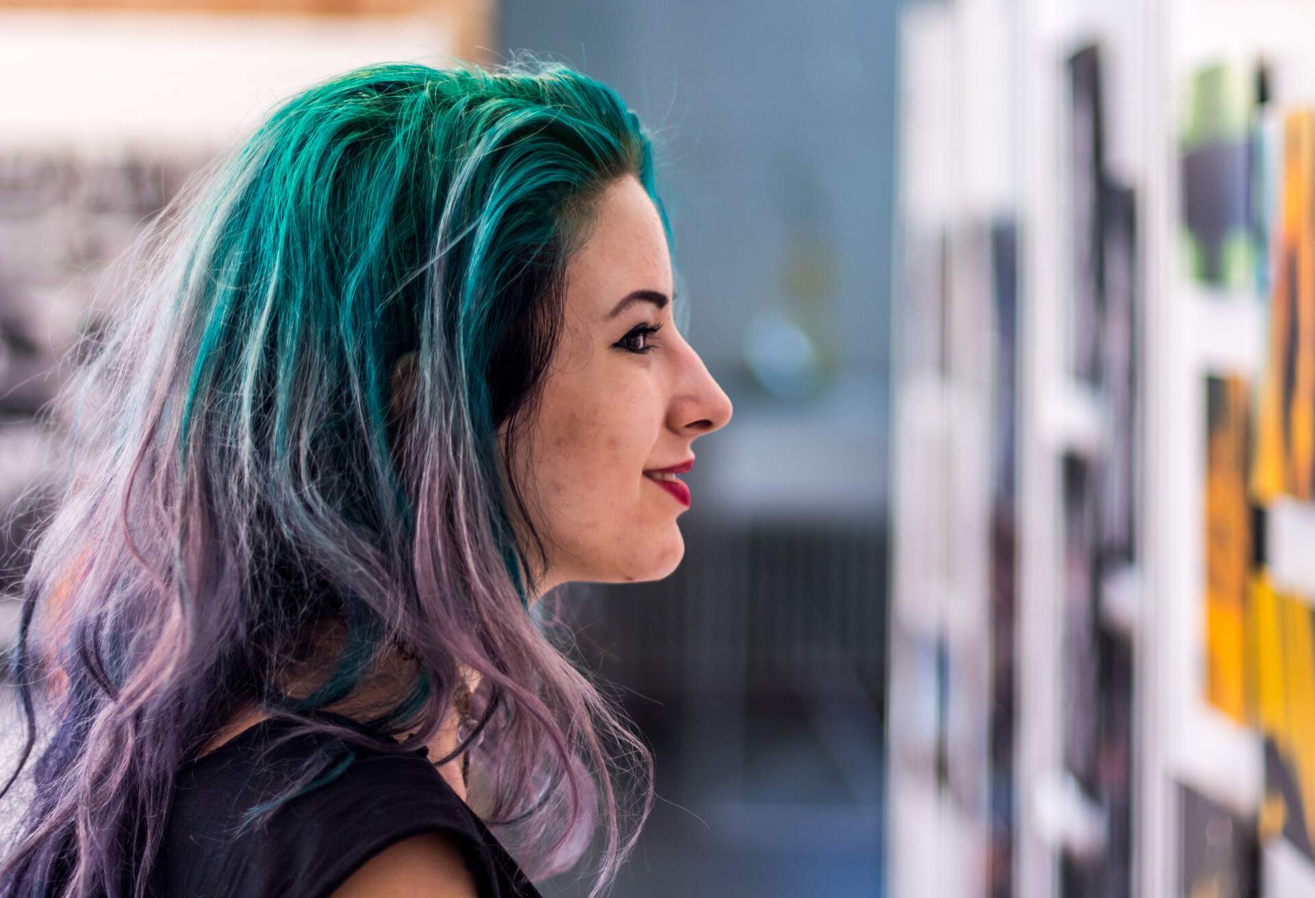 Young woman in gallery waching photos