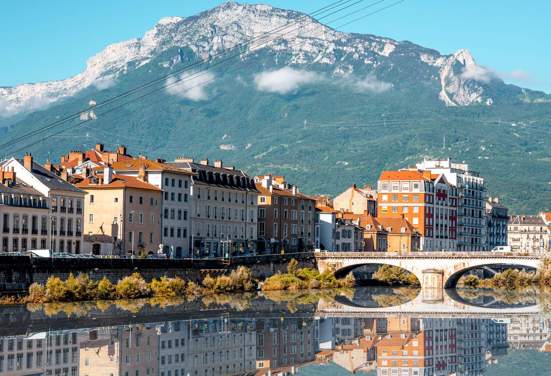 Morning cityscape view with mountains, river and bridge in Grenoble city on the south-east of France