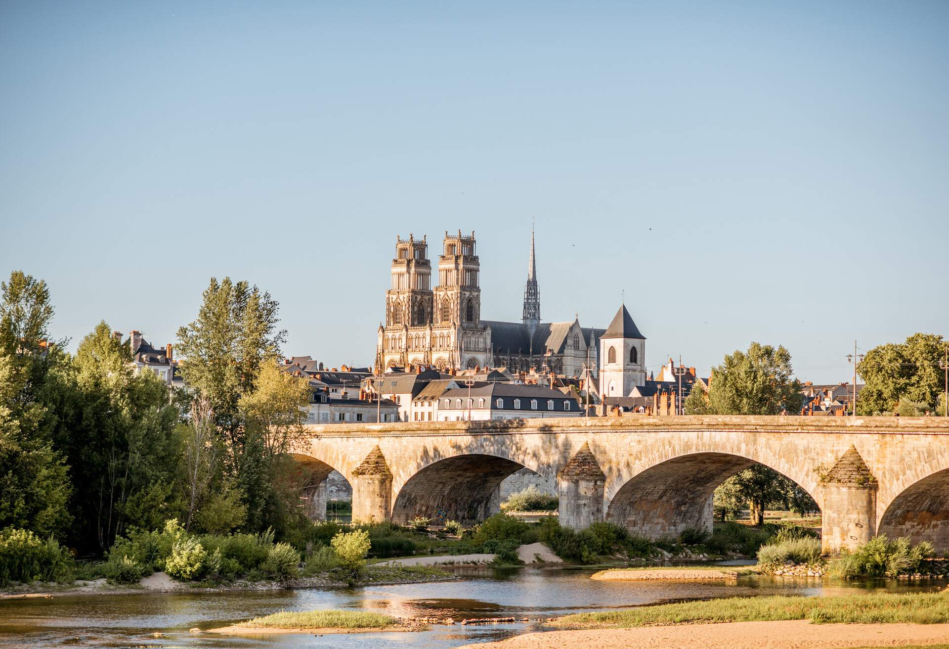 Landscape view on the river and old arch bridge in Orleans city during the sunset in France; Shutterstock ID 711028963