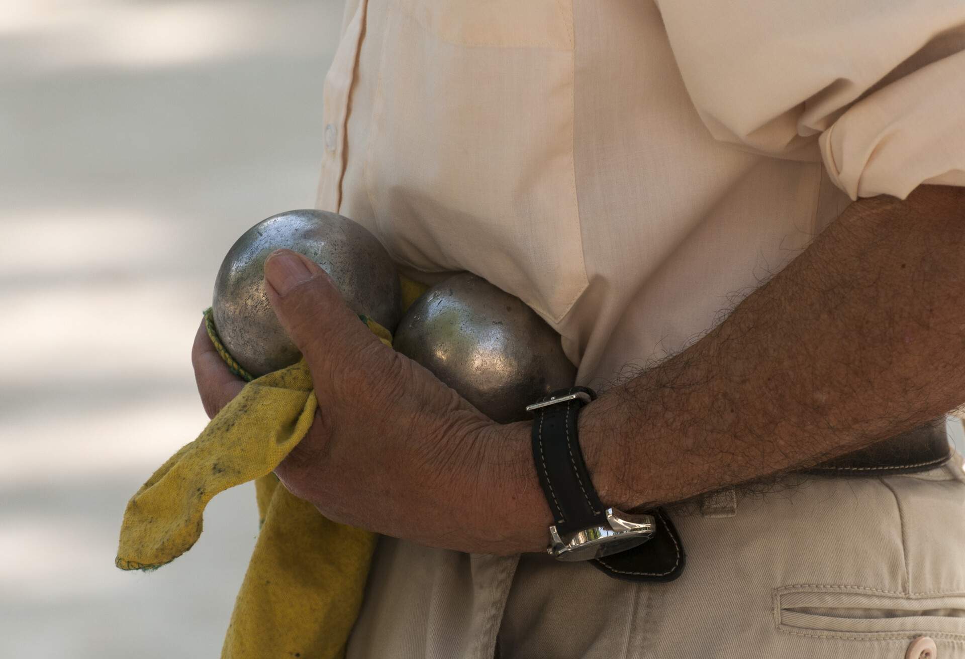 France, Gard, Nimes, Man holding petanque balls.