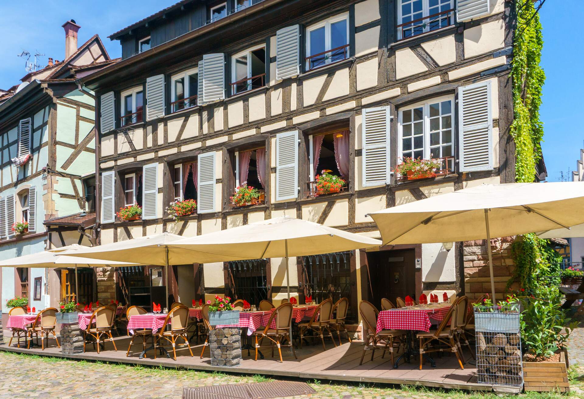 Cafes and restaurant in Petite-France in Strasbourg, Traditional colorful houses in La Petite France, Strasbourg, Alsace, France