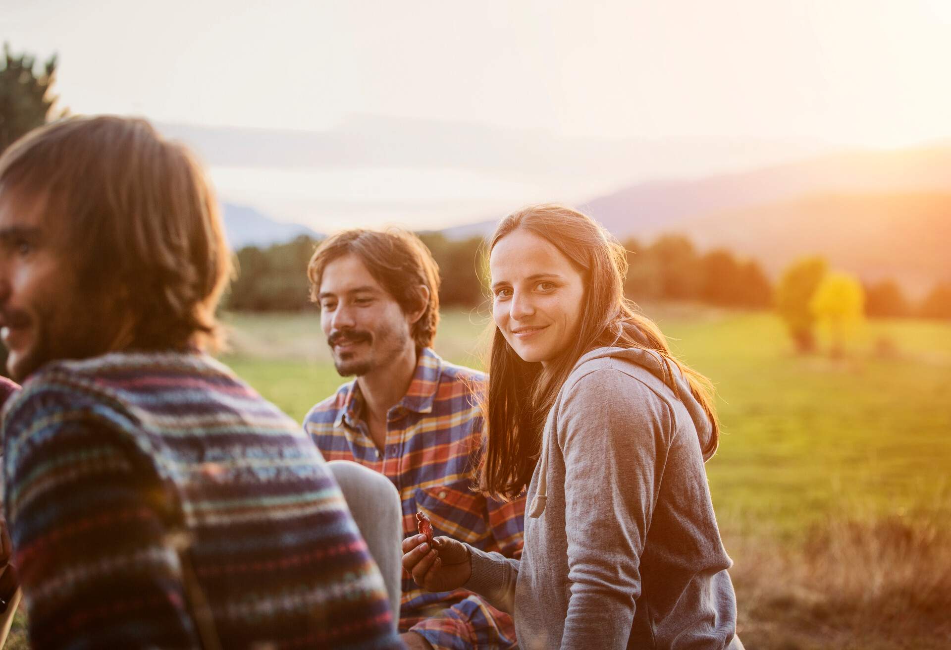 Portrait of smiling girl with friends at campsite