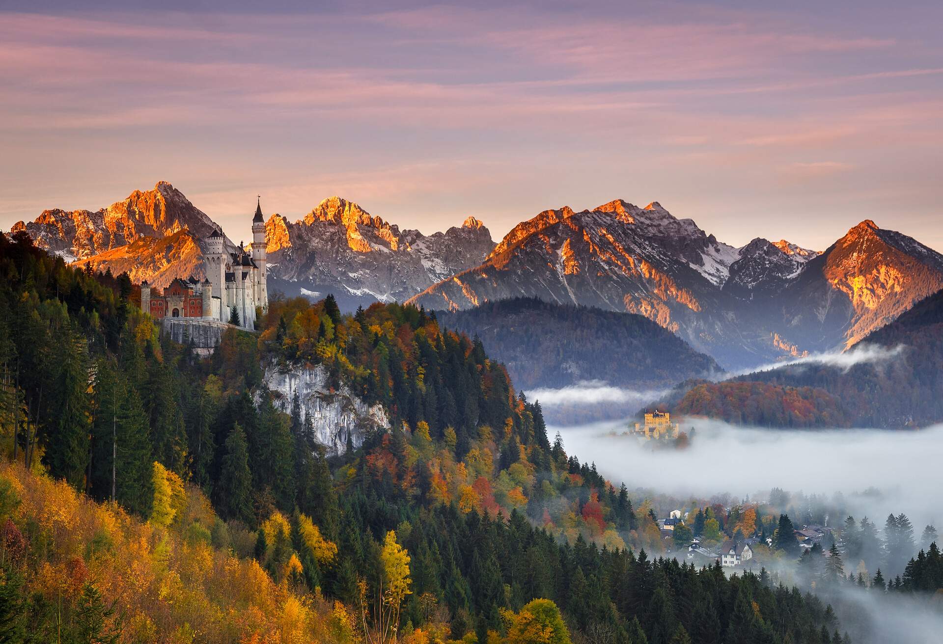 Wow, it was a crazy trip to the Alps. 1200km within 27 Hours without sleep. .My first destination for the sunrise was actually the Geroldsee in Bavaria. The castle Neuschwanstein was on my way, so I wanted to take a look on it. Well, I didn't see much first because the castle will not being illuminated in the night. But then I saw some low fog patches in that area and decided to wait here for the sunrise - and that decision has more than paid off. Great point of view, autumn foliage, fog and alpenglow in the background - it could hardly be better.