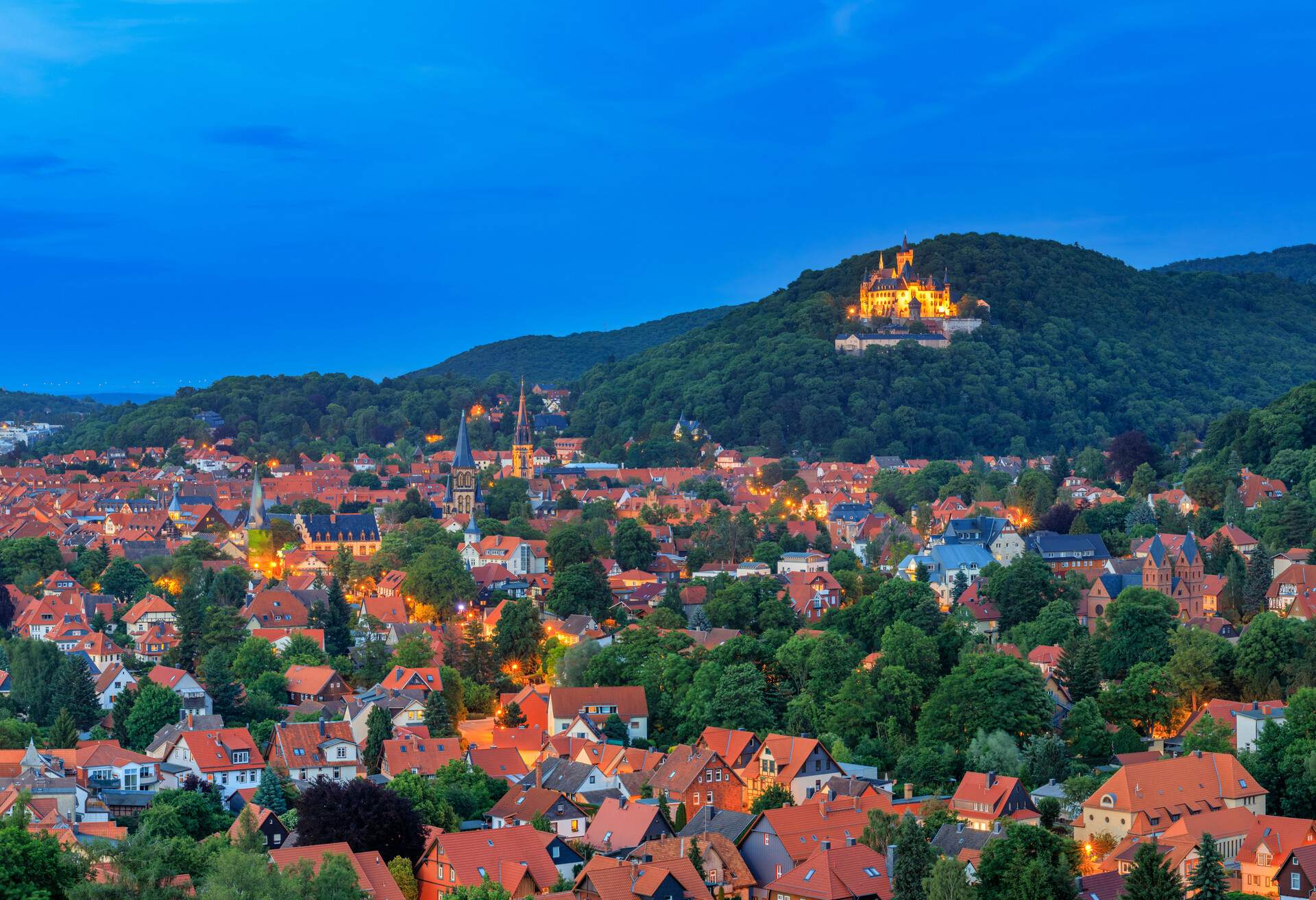 Wernigerode cityscape in twilight..The castle (Schloß Wernigerode) of the princes of Stolberg-Wernigerode in bright illumination rises high above the town.