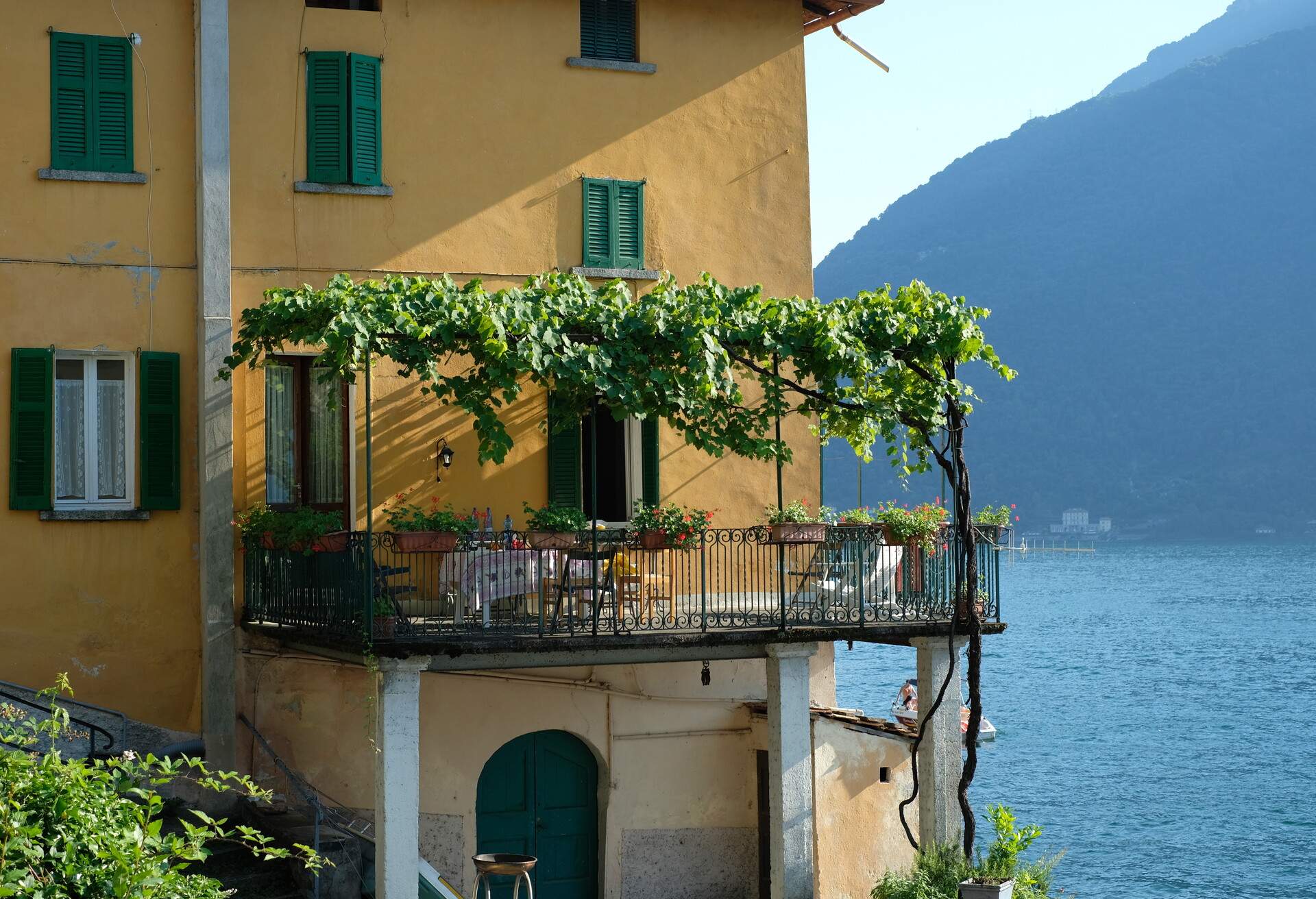 Facade of the House close to Lake Como with green pergola and terrace