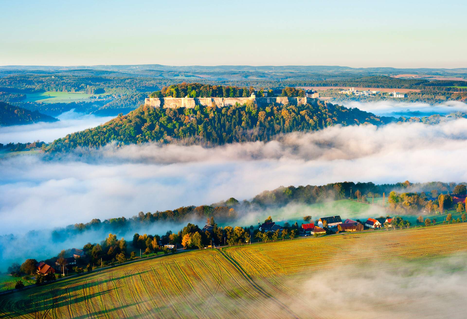 festung königstein at dawn, famous castle in saxon switzerland elbsandsteingebirge, germany, mist over elbe valley