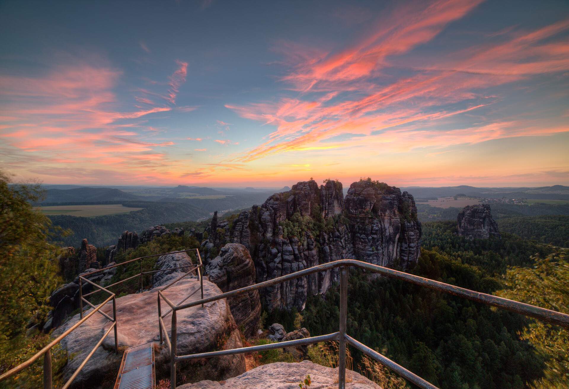 Sunset in Schrammstein, forests and colored sky in the Germany Switzerland.