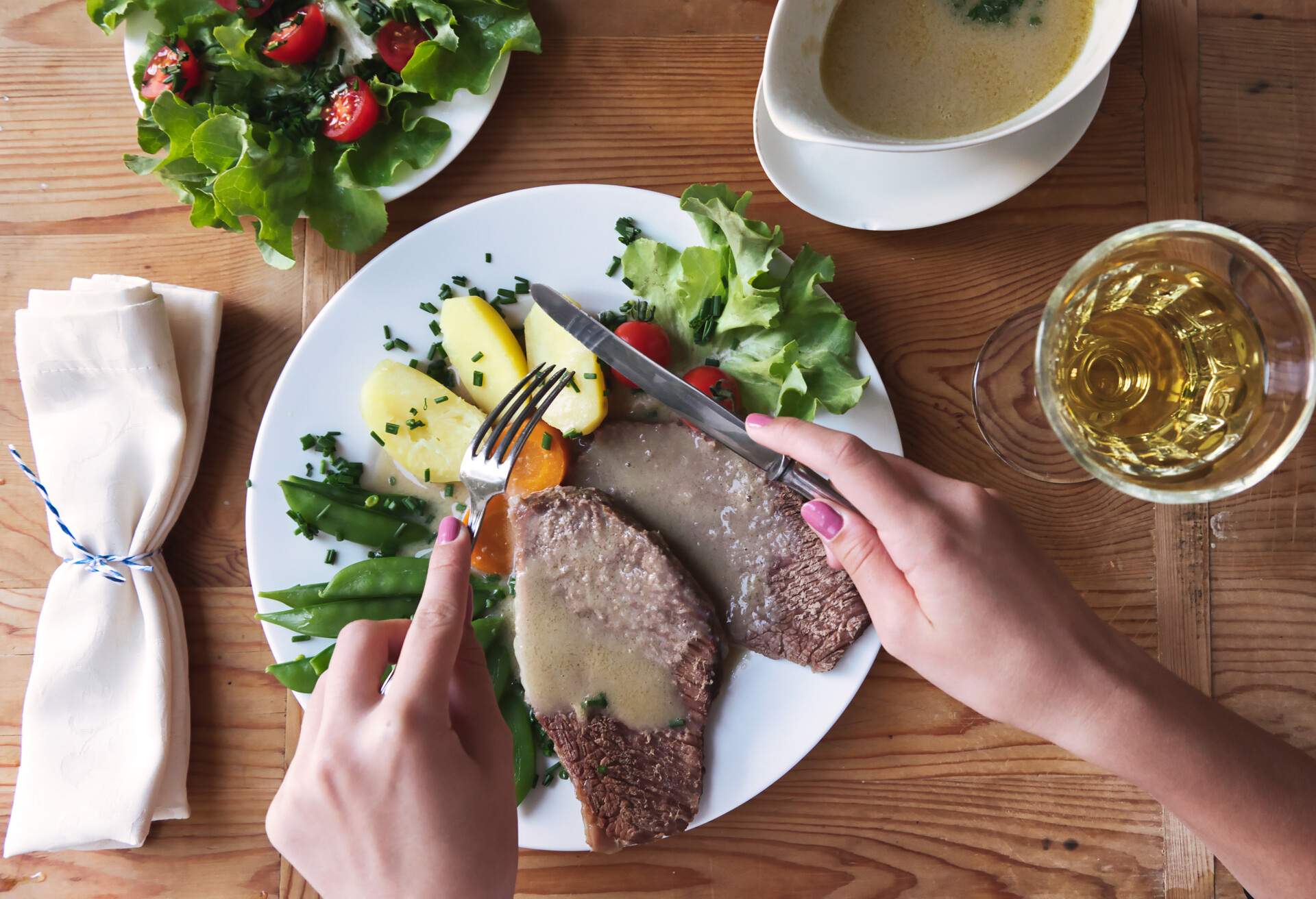 female hands cutting boiled fillet 