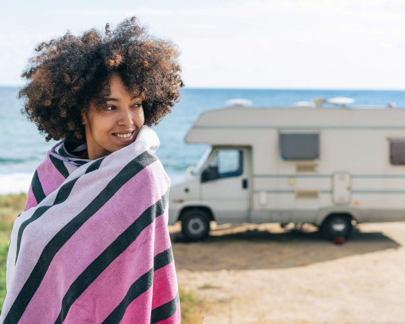 THEME_PEOPLE_WOMAN_CAMPING_CAMPERVAN_BEACH_SEA_GettyImages