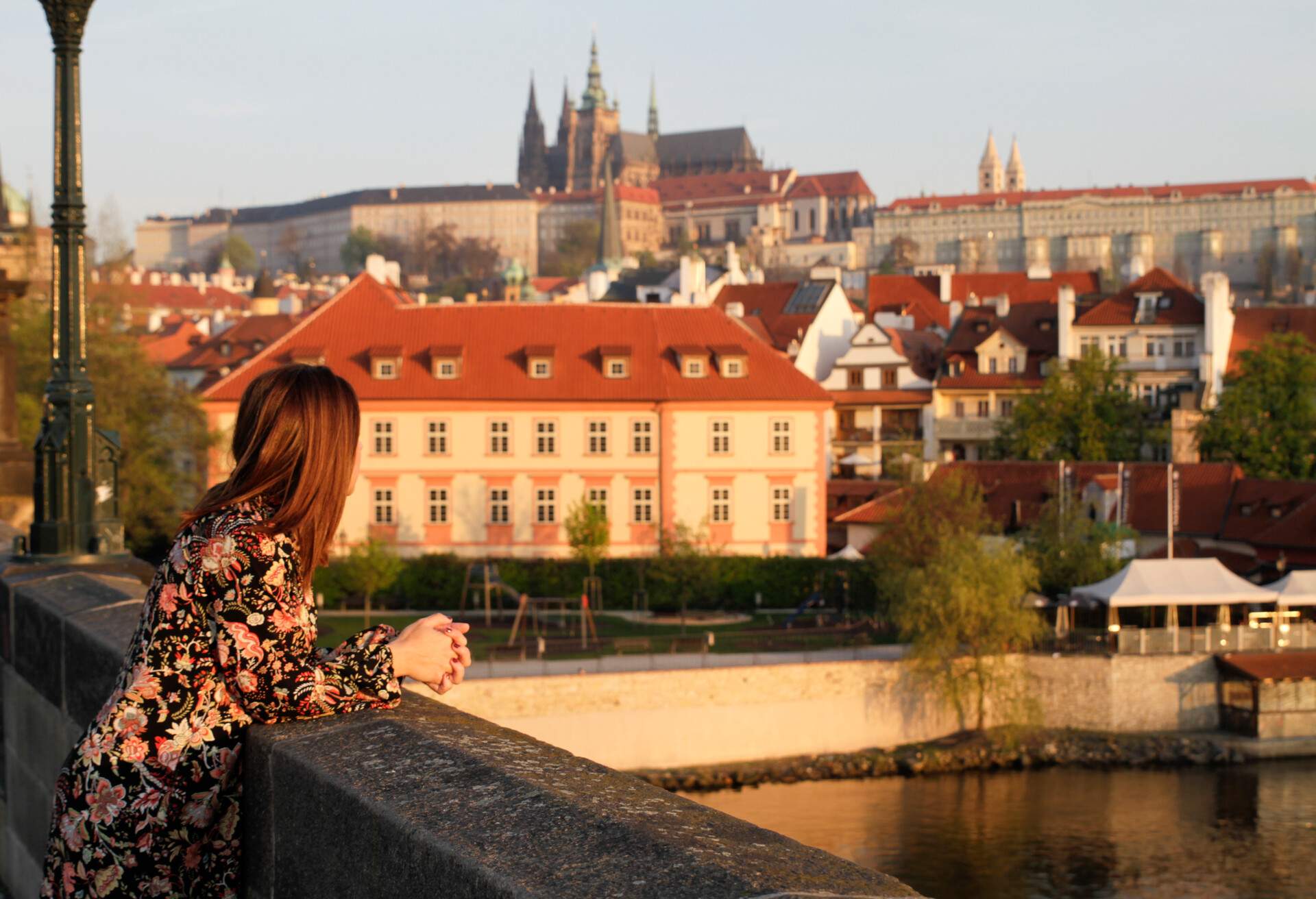 Tourist enjoying sunrise with view to Prague Castle & Mala Strana, Prague, Czech Republic