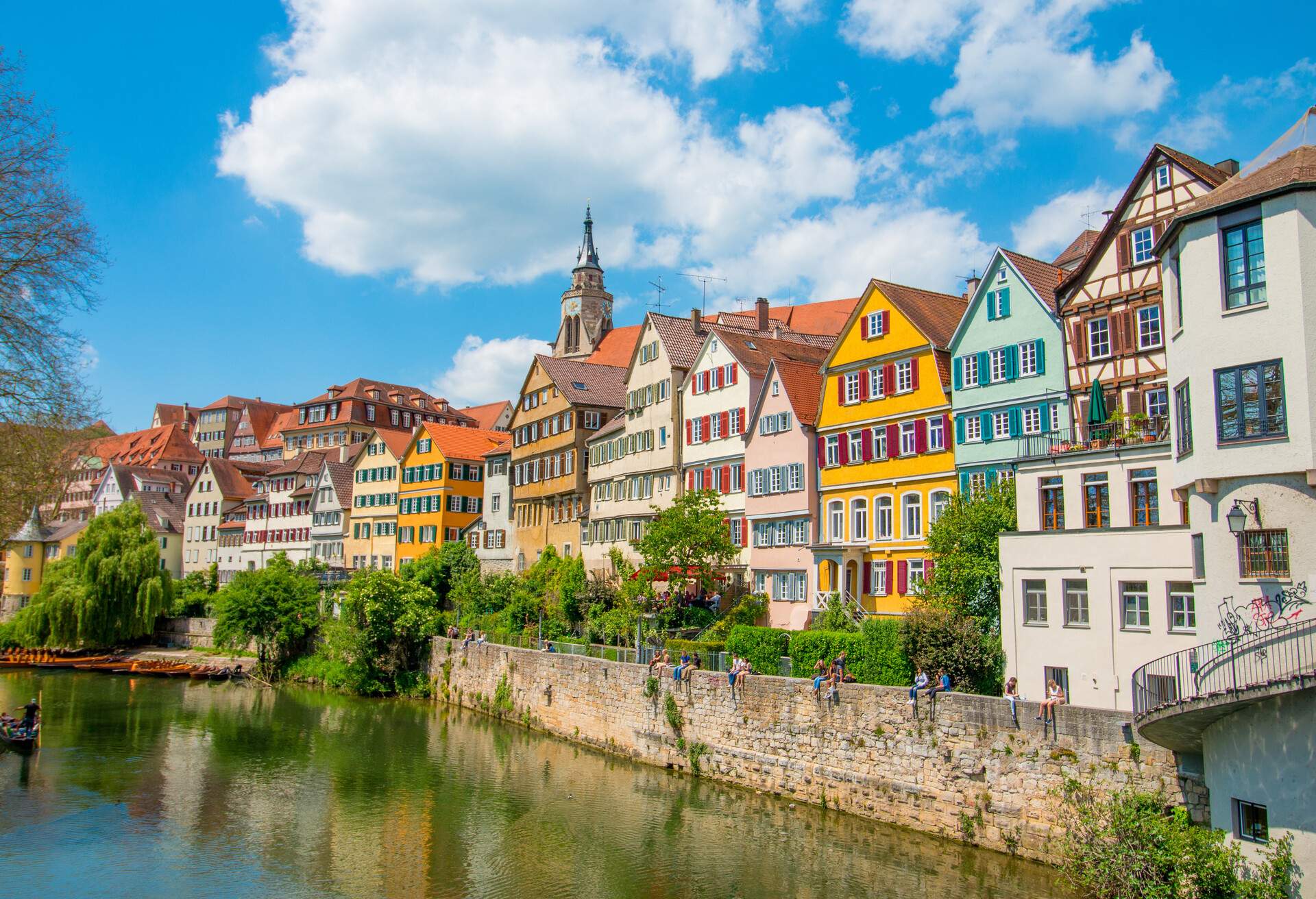Tuebingen in the Stuttgart city ,Germany.Colorful house in riverside and blue sky. Beautiful old city in Europe.People sitting on the wall.Boats wooden moored at dock.; Shutterstock ID 665140723