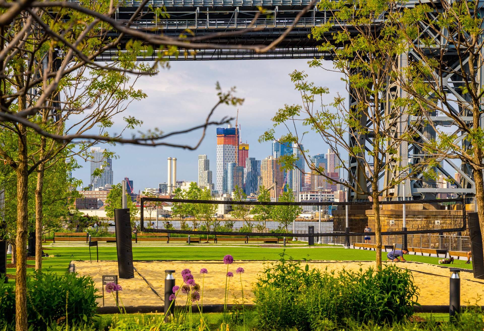 View of Manhattan, New York, from Domino Park in Brooklyn. New York is the largest city by population in the USA and has millions of yearly visitors.